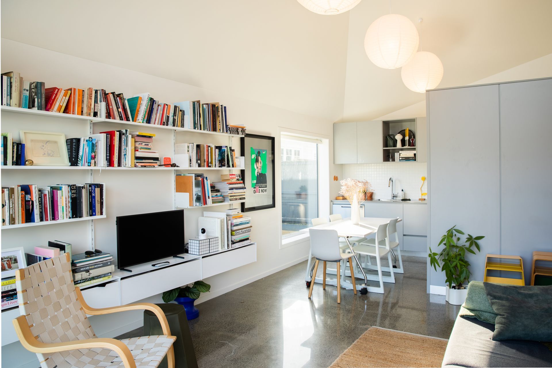 The white walls are the perfect backdrop for the homeowner's collection of art and books.