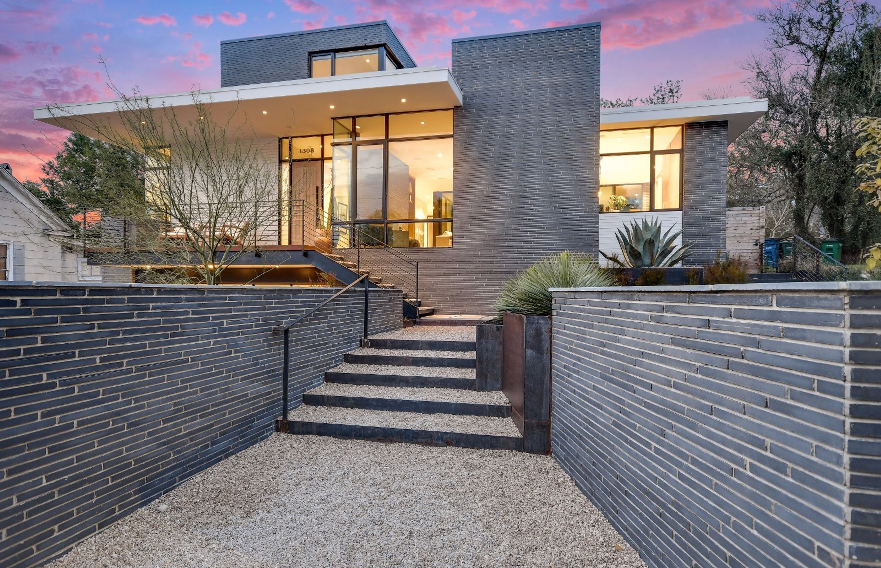 Dramatic proportions inherent in long-format bricks accentuate the linear feel of this walled entrance.