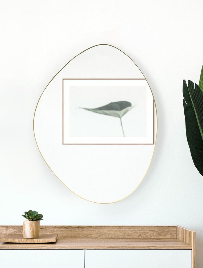 A pebble-shaped bathroom mirror that adds a touch of nature-inspired design to a bathroom. Featured product: Pebble Shape Mirror