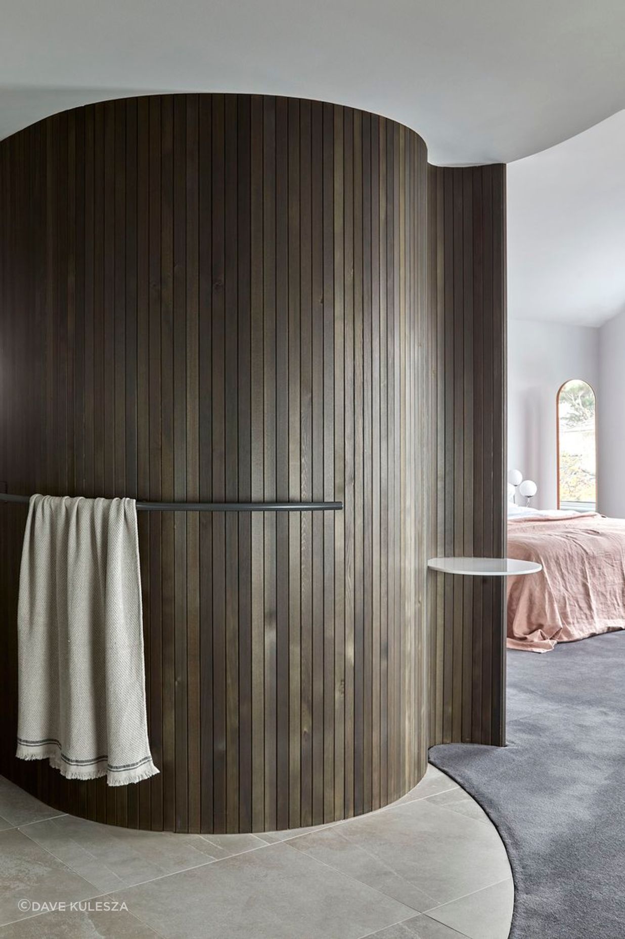 The curved wall of the sauna in the bedroom suite.