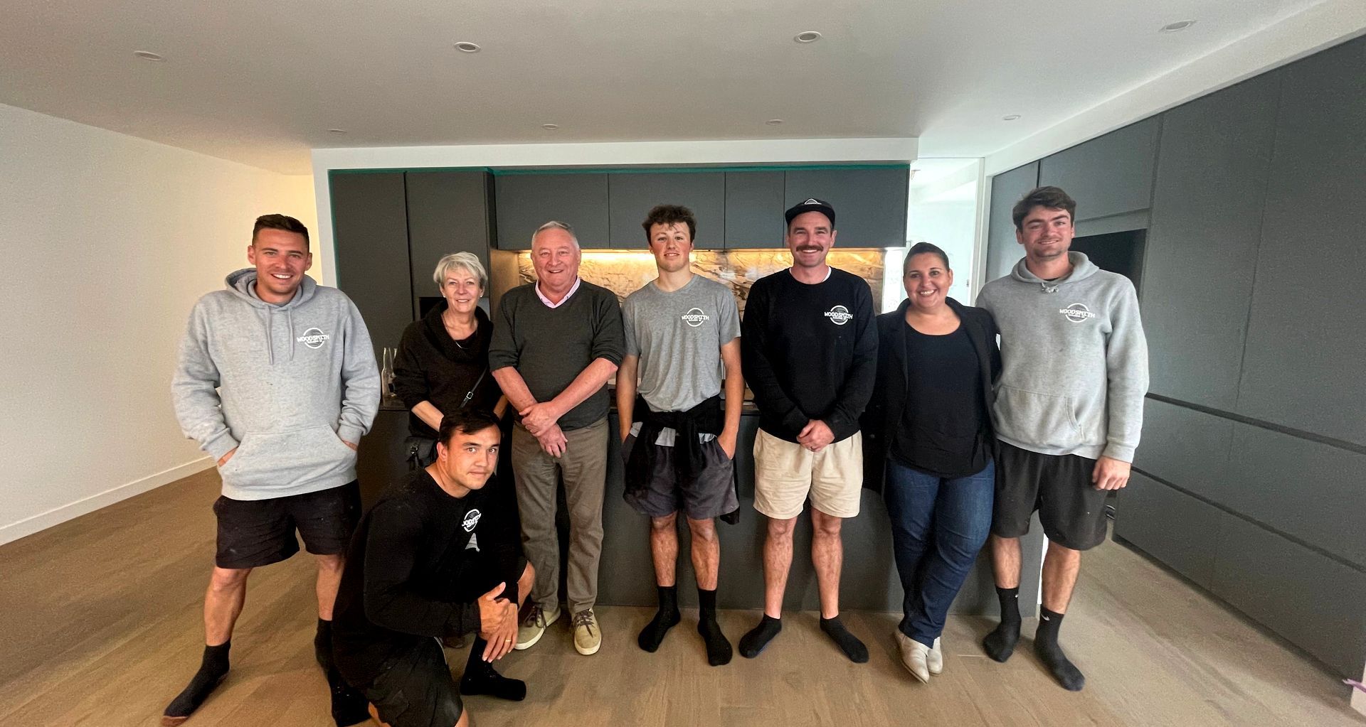 The Woodsmith team, Romé and two happy clients in their finished kitchen.