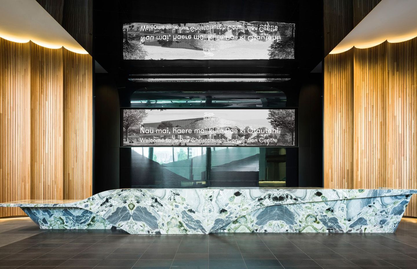 A magnificent stone island reception desk reflects the same curves found on the exterior of the building.