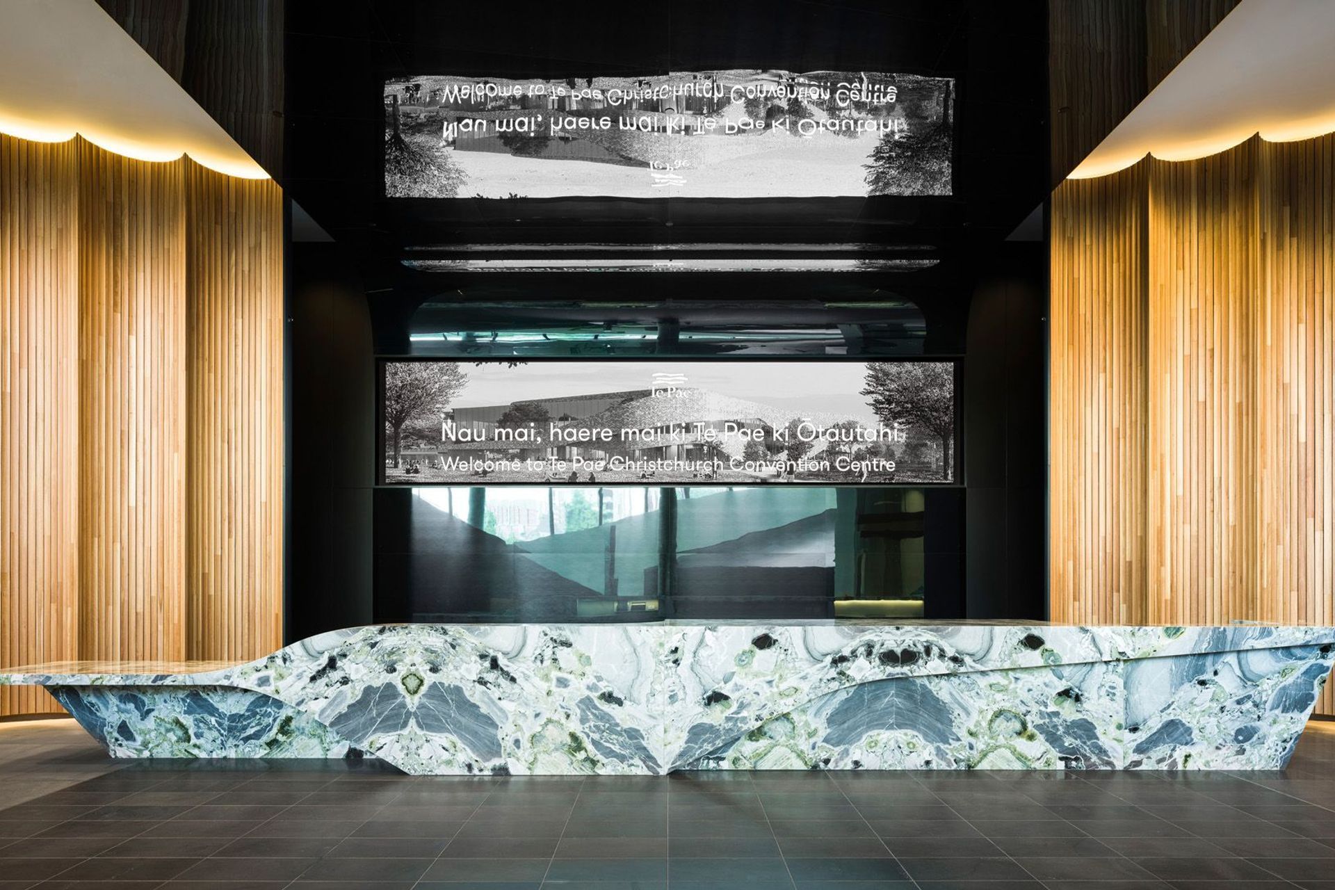 A magnificent stone island reception desk reflects the same curves found on the exterior of the building.