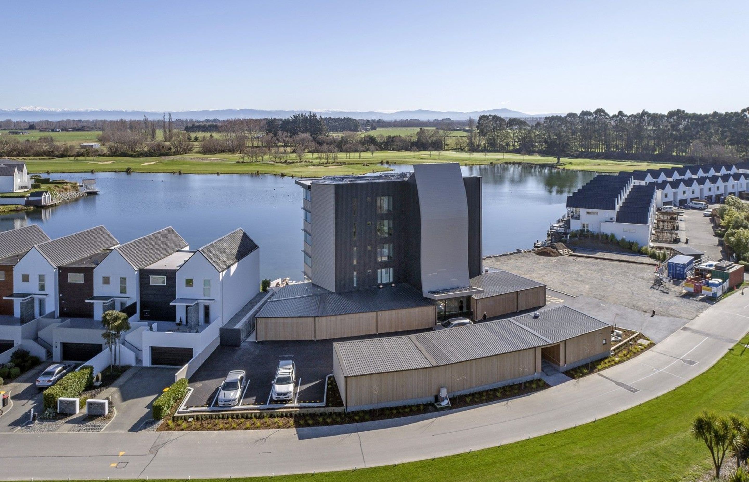 The sculptural timber staircase adds visual interest to the roadside façade.