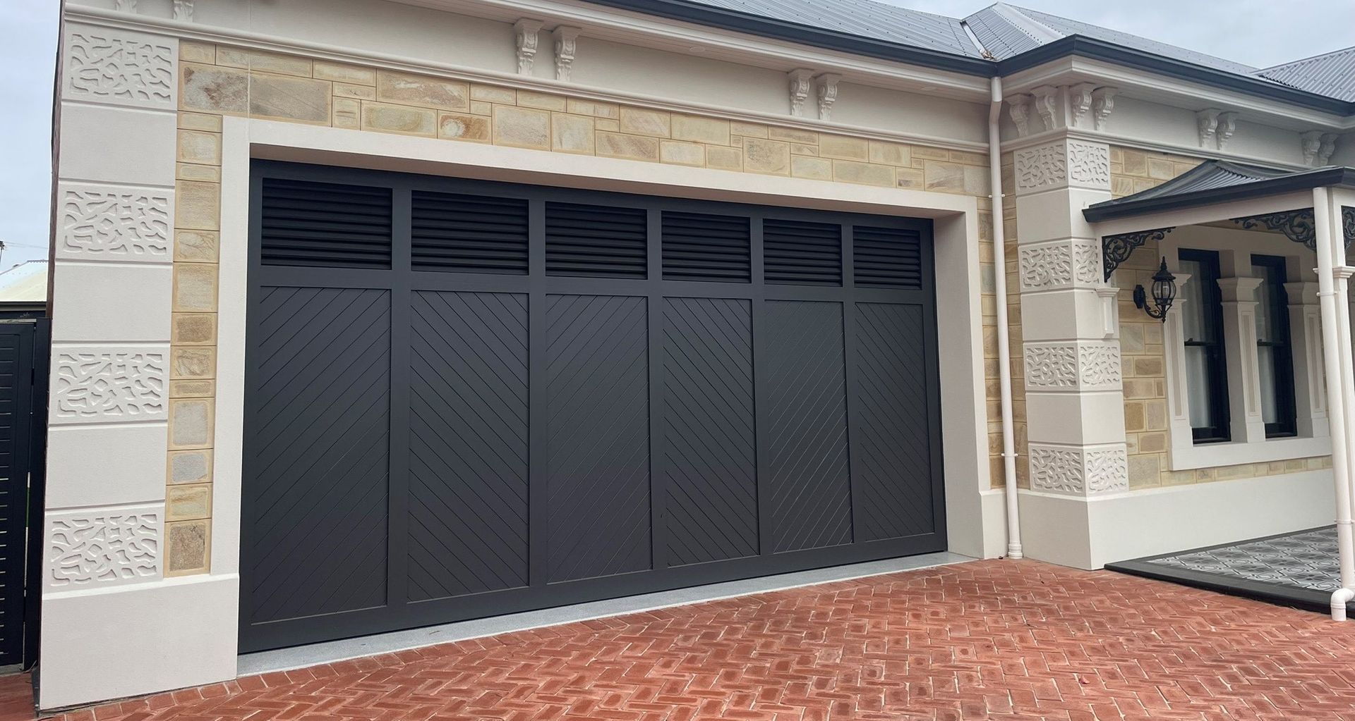 Western Red Cedar Tilt Door painted in Monument Matt featuring Louvred Windows | Steel-Line