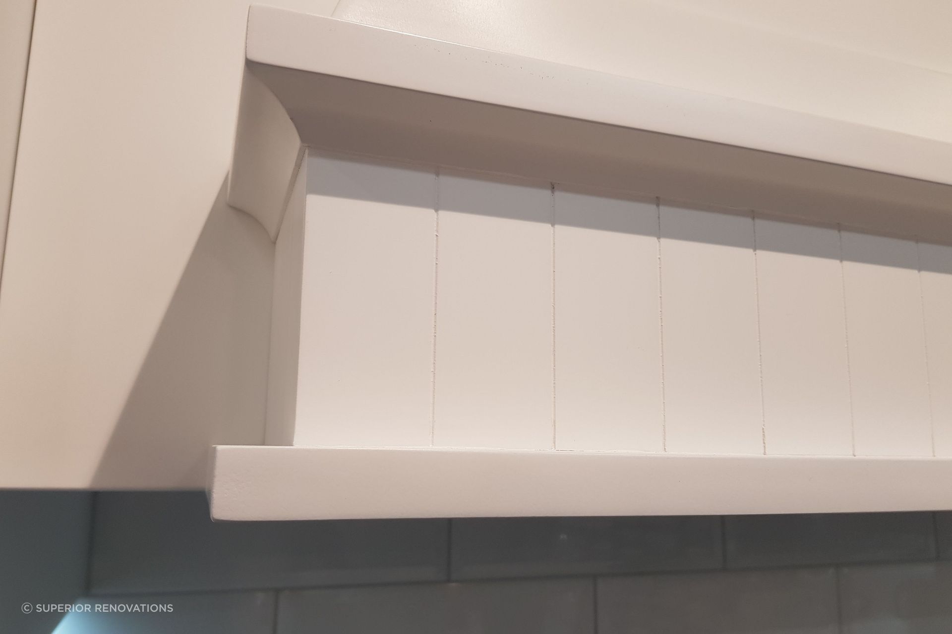 Handcrafted detailing in our hooded rangehood in our kitchen showroom in Auckland