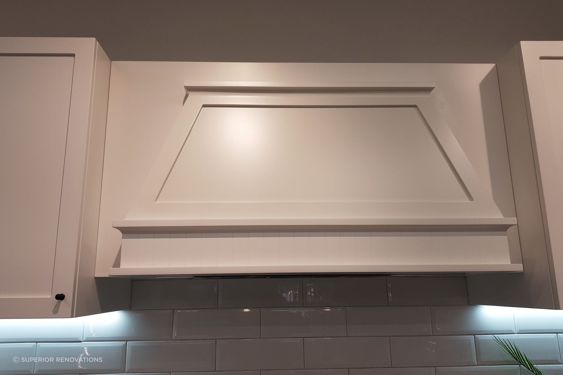 Handcrafted hood on top of a range hood to give it an appearance of a chimney