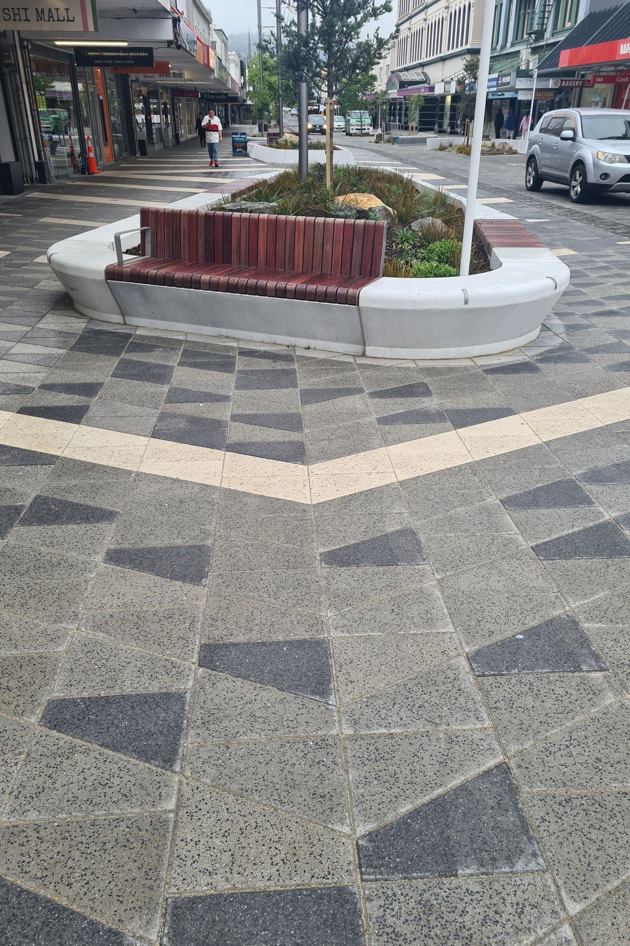The streetscape offers places to sit and enjoy the paving patterns and through them learn more about the area's history.