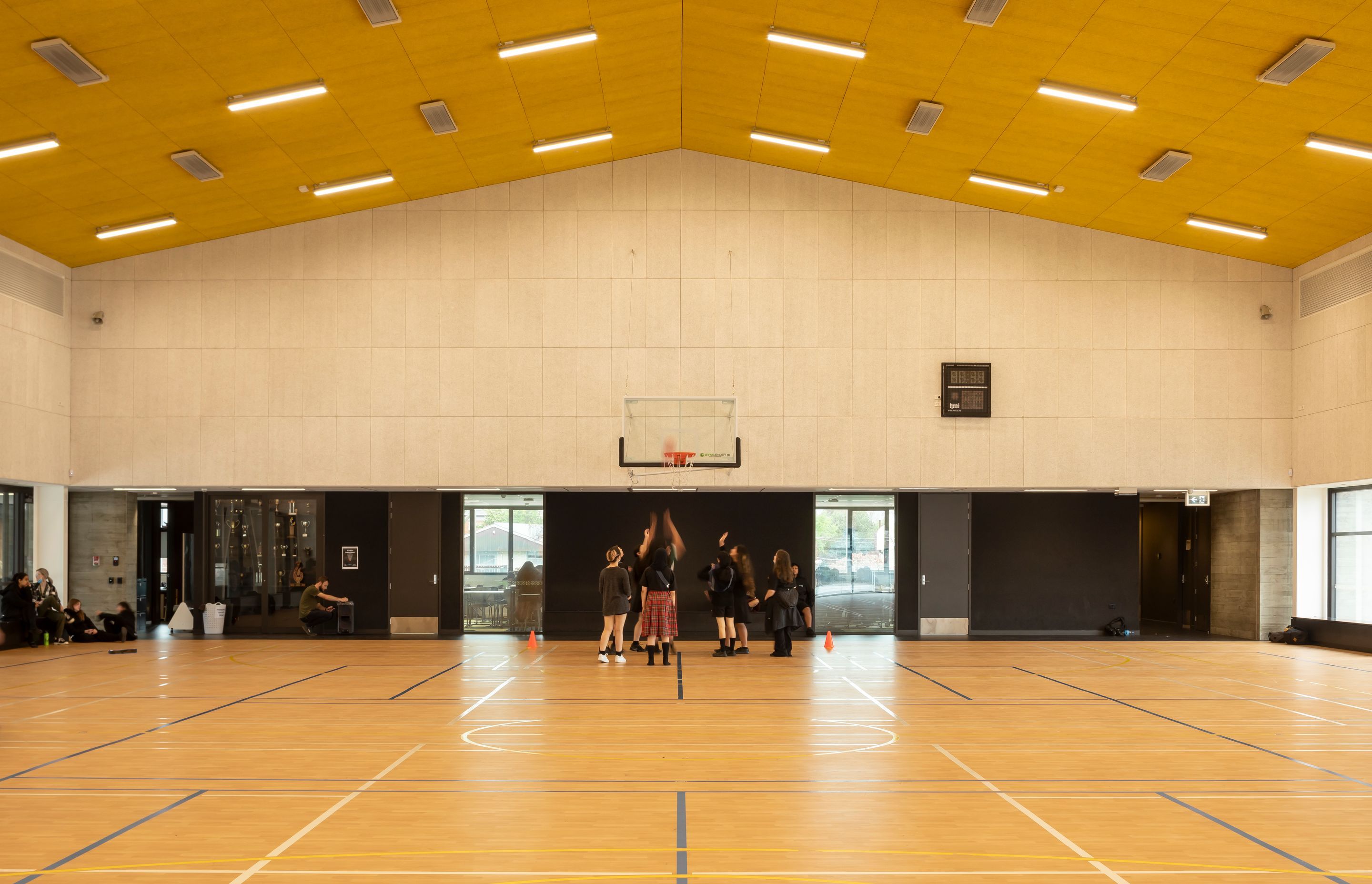 The gymnasium features yellow AUTEX acoustic panelling on the ceiling, which helps reduce noise.