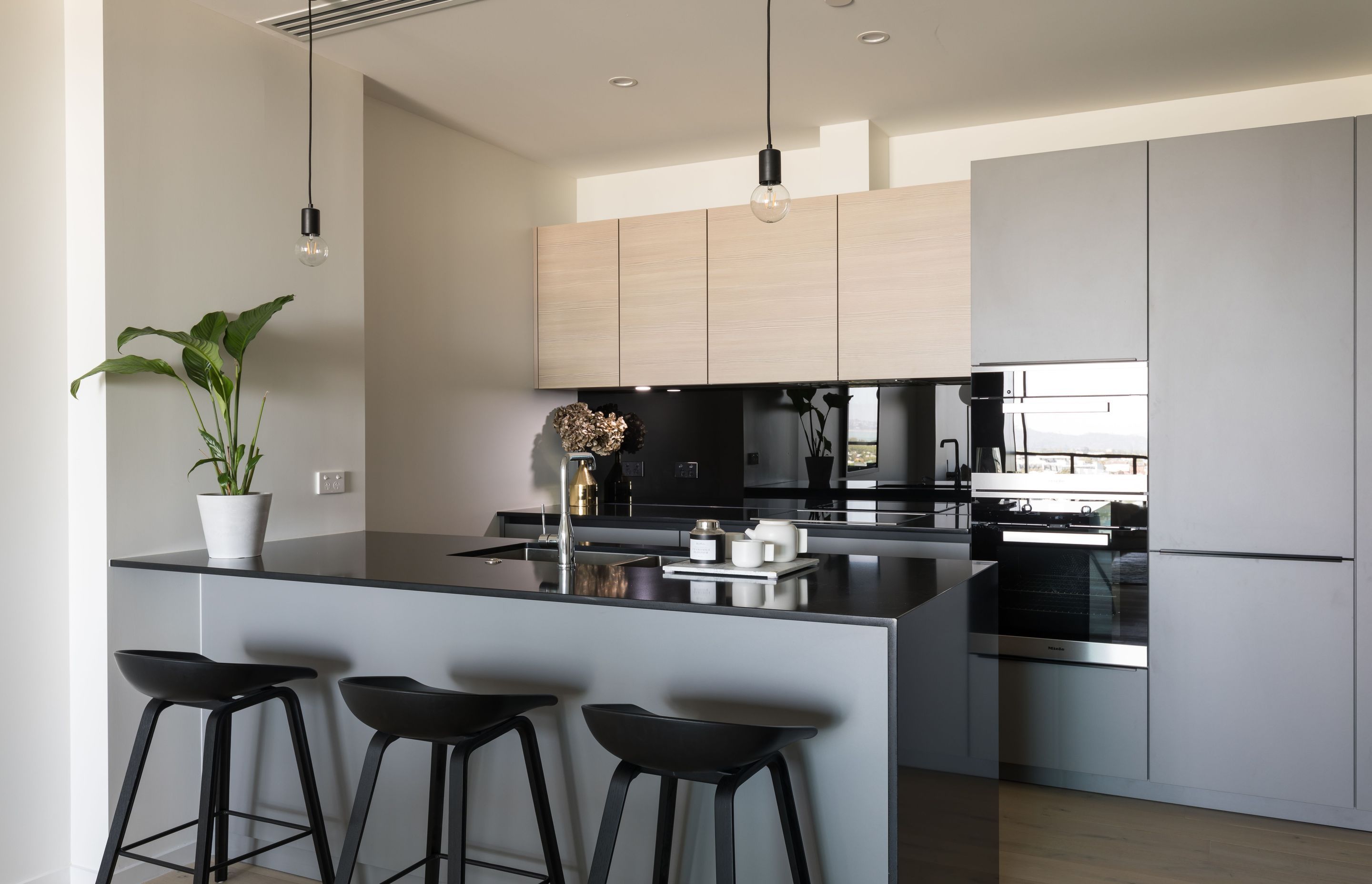 The secret to a great apartment kitchen is use warm, inviting tones that complement the overall palette and integrate the space into the overall scheme.