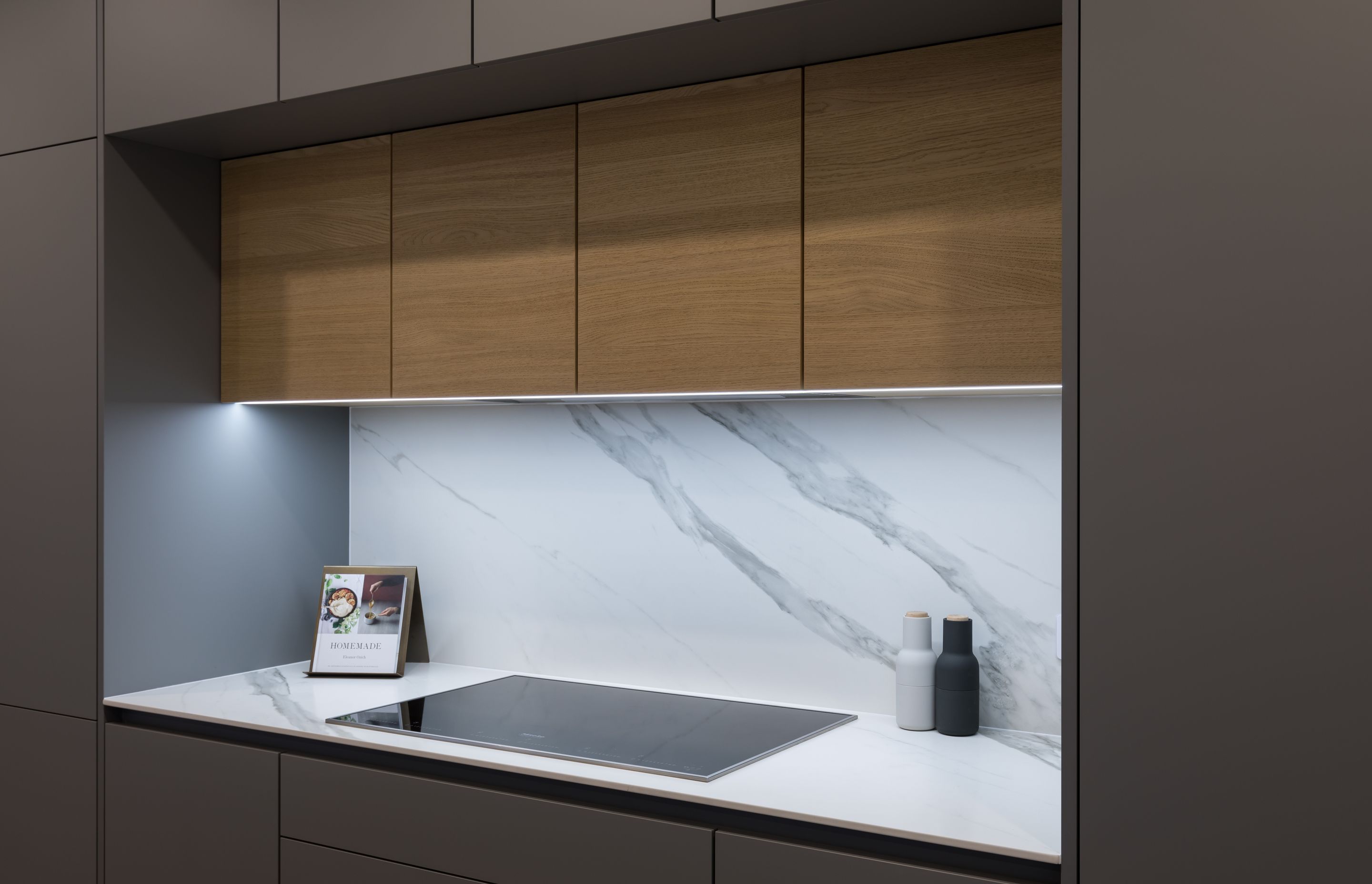 The combination of Stone Grey, Classic Oak and marble-look Opera by Dekton finishes answers the clients' brief for a limited material palette.