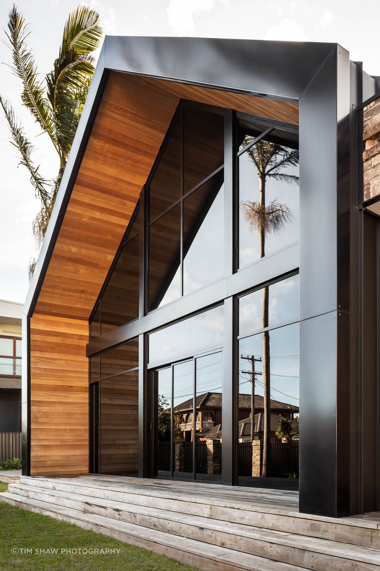 Timber warms and softens the strong lines of the facade.