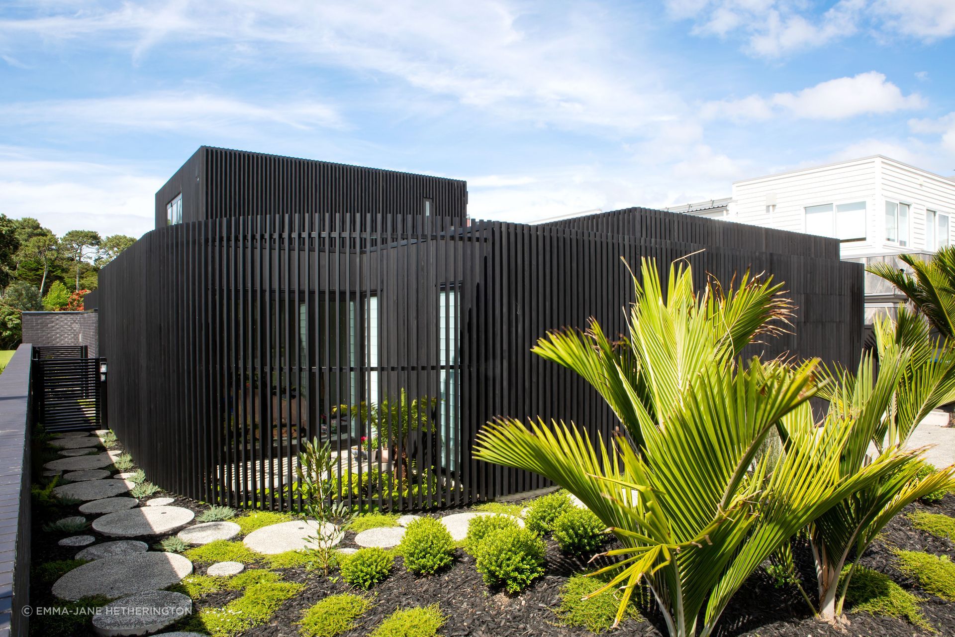 The curve that leads to the front door. Beyond the gate is the black brick boundary fence that allows the family access to the public park: the bricks were another new material, discovered by homeowner George Crawford, and are Tenerife by Austral Bricks.
