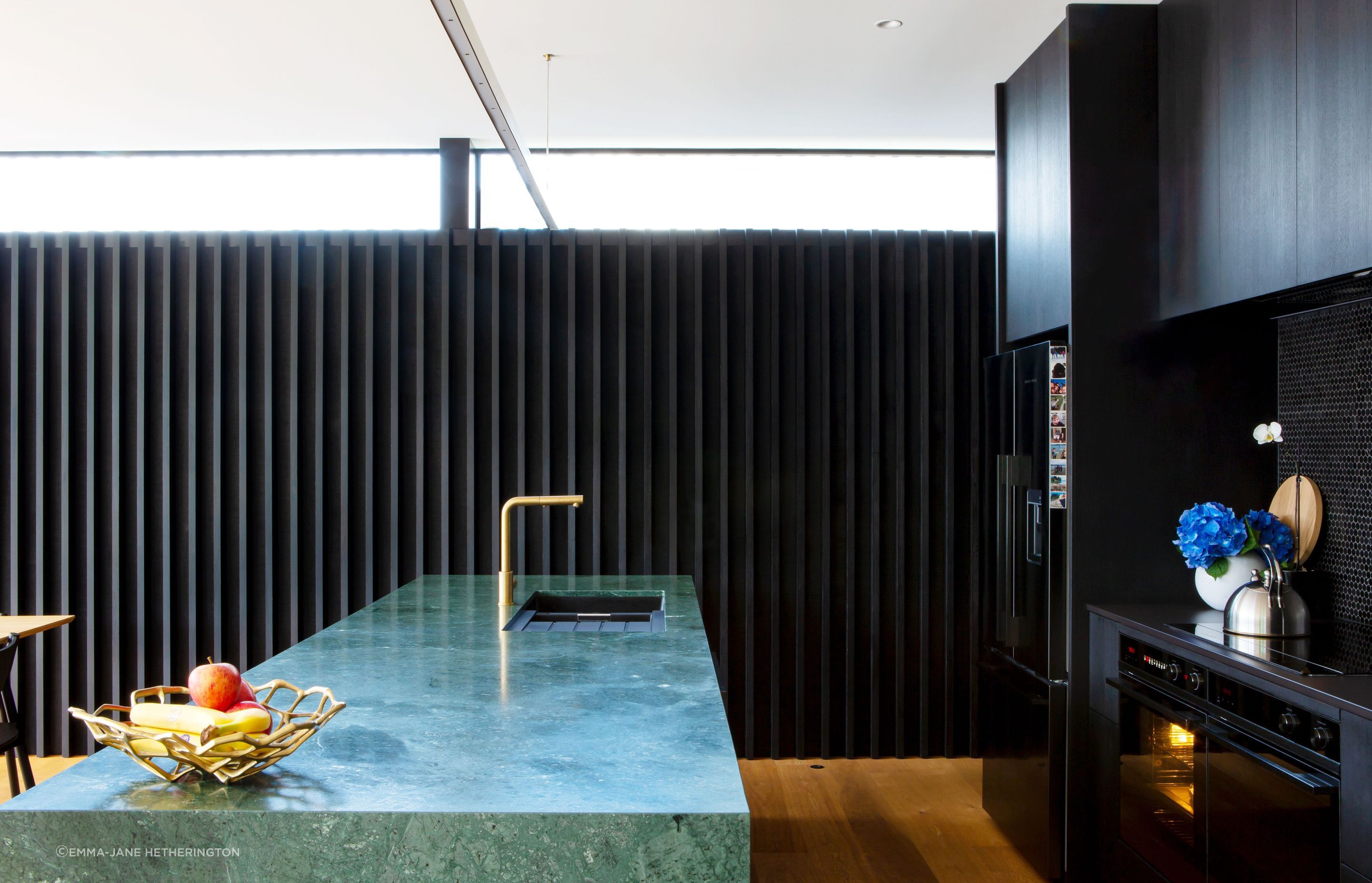 The Buddy mixer is from Plumbline and the appliances are Fisher &amp; Paykel. Dorrington Atcheson Architects project architect Sam Lennon first suggested the green marble island even though previous clients had shied away from such a bold statement.