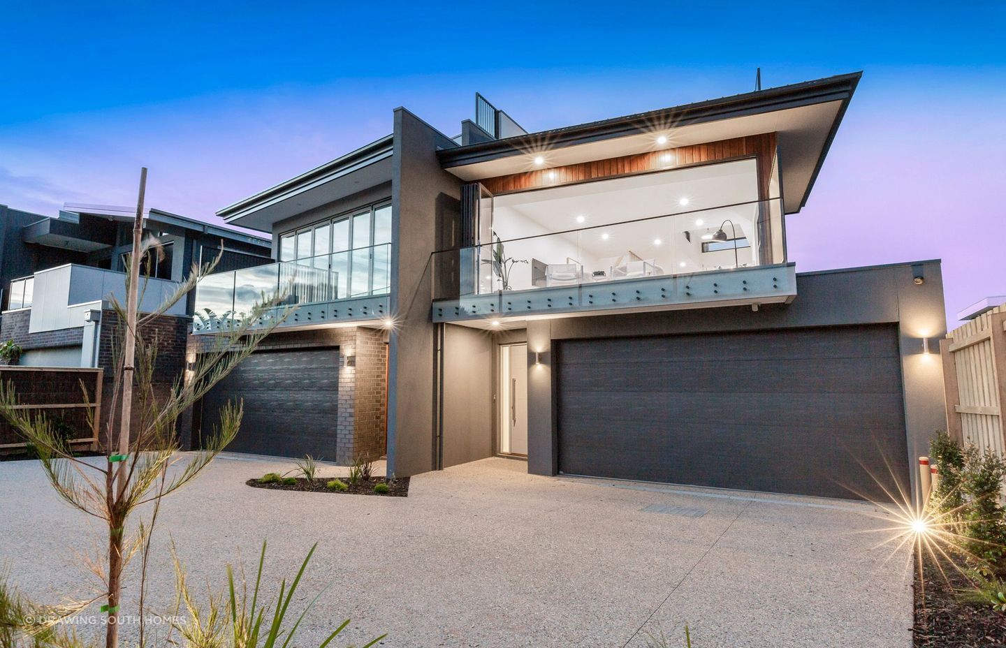 These generously-sized driveway spaces are beautifully adorned with lush greenery.