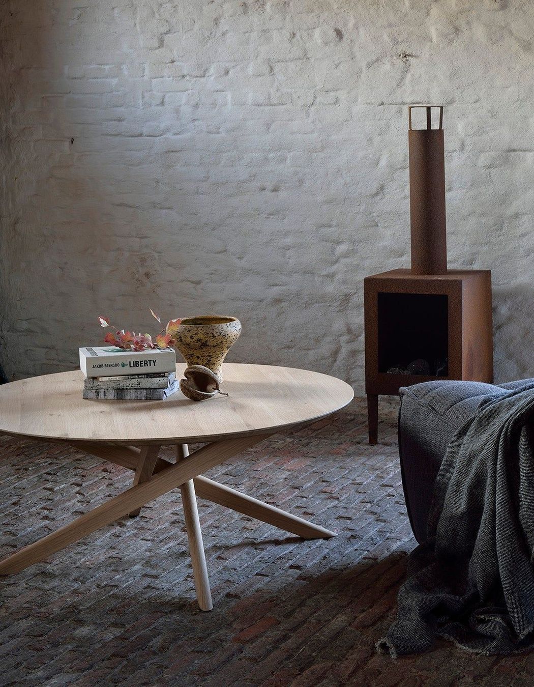 A smooth, round coffee table fits easily in rooms of different styles.