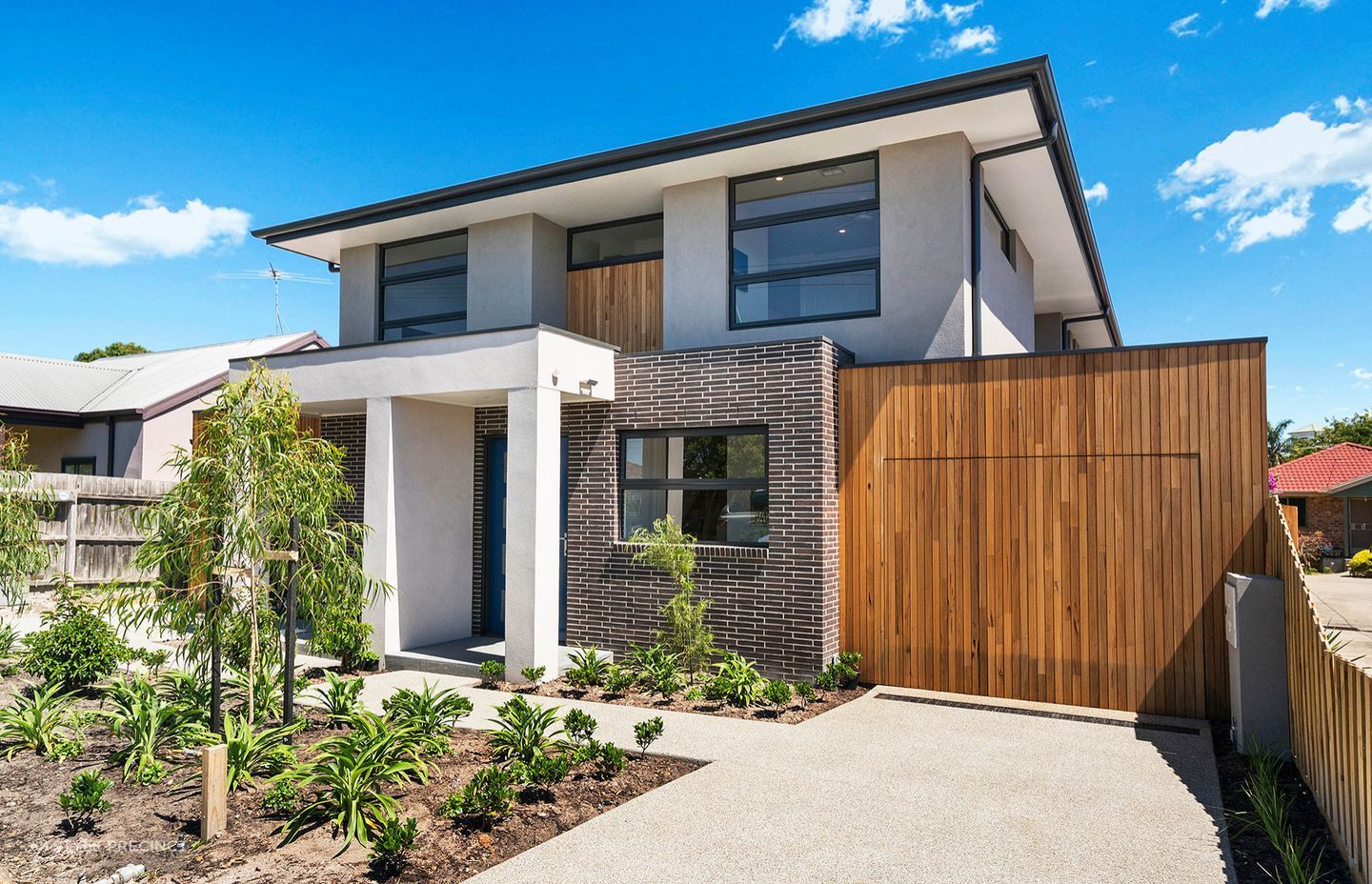 The 'hidden' garage door blends seamlessly with the timber facade.