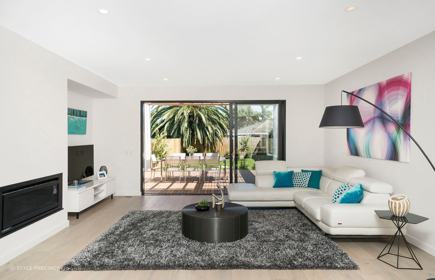 The spacious living area opens out onto a sun kissed outdoor deck and garden area.