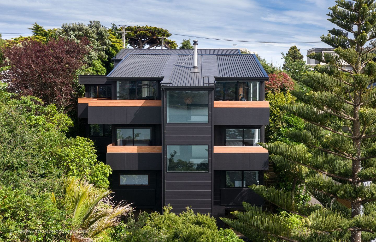 The house’s protective facade, designed to enhance views from the interior out across the harbour.