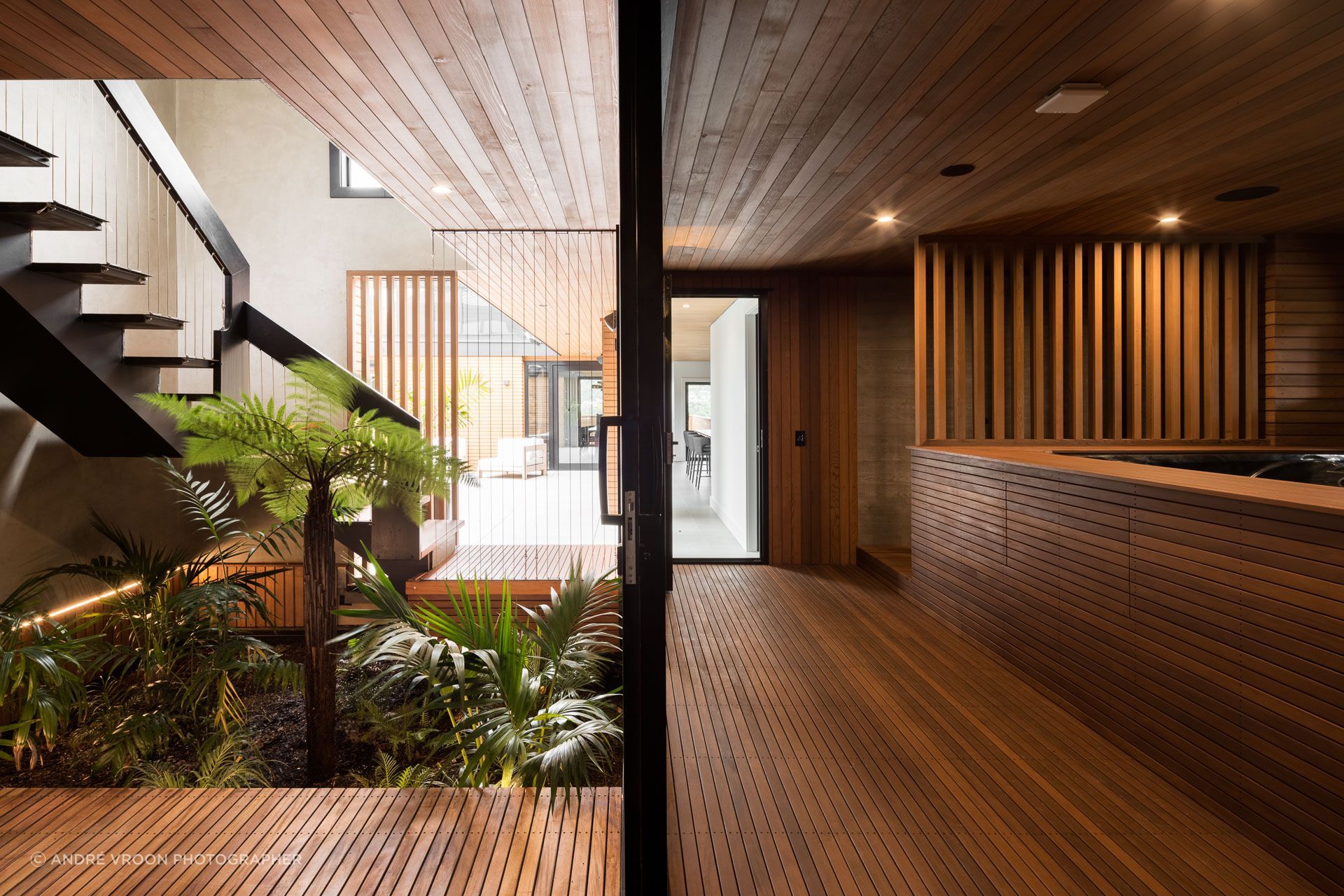 The stairwell and neighbouring spa pool/outdoor shower, post-renovation. The point of entry has been revitalised with a vibrant garden and a re-defined navigation path.
