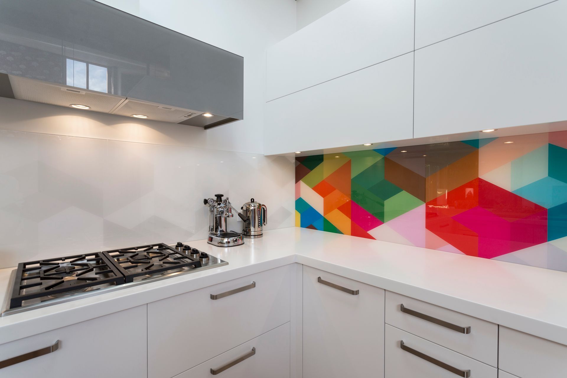 This kitchen designed by Toni Roberts from Kitchen Architecture demonstrates how you can create a piece of art that has high impact. Note the bright geometric pattern is replicated in grey tones on the adjacent wall and the overall effect is still as stunning today as it was in 2015 when it was installed.