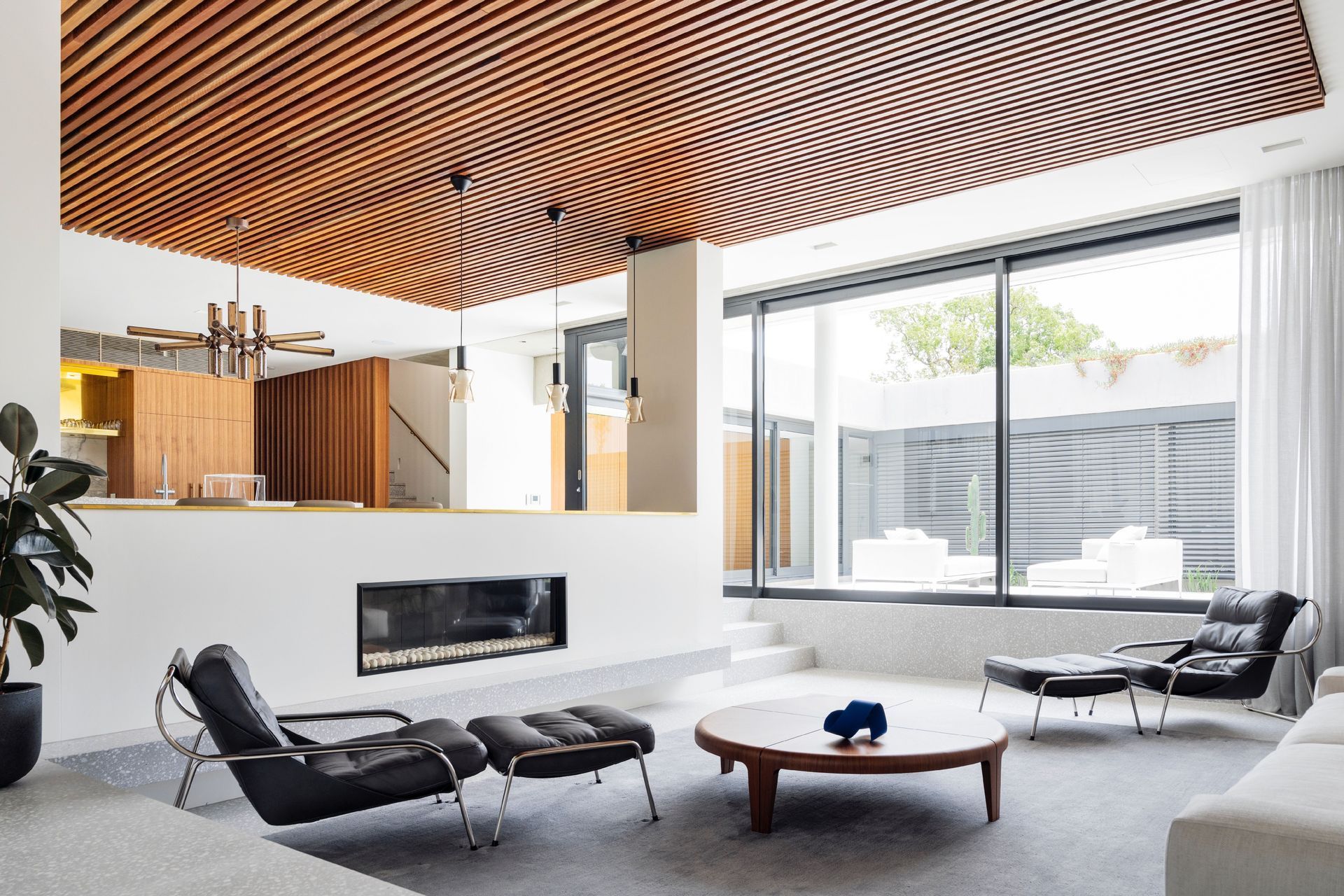 Natural stone and wood have a strong presence in this exquisite Mid-Century House - Photography: Justin Alexander