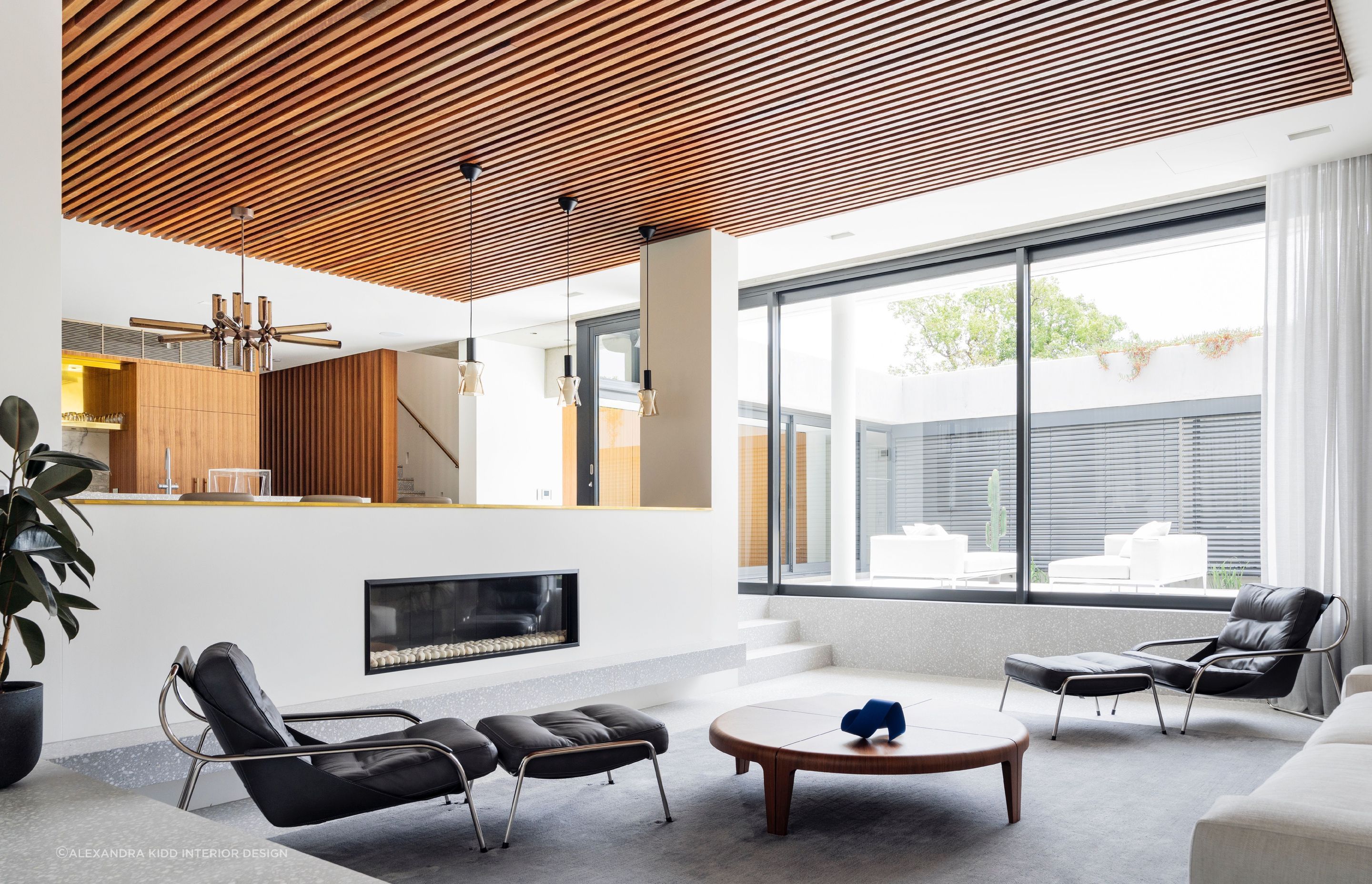 Natural stone and wood have a strong presence in this exquisite Mid-Century House - Photography: Justin Alexander