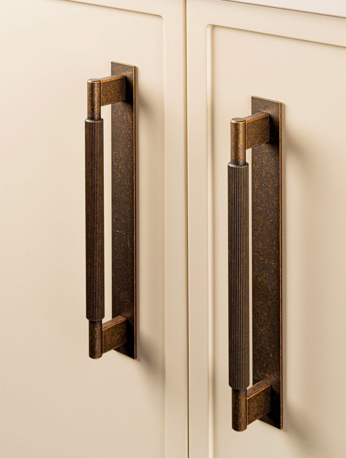 Momo Handles Arpa range in bronze with backplate.