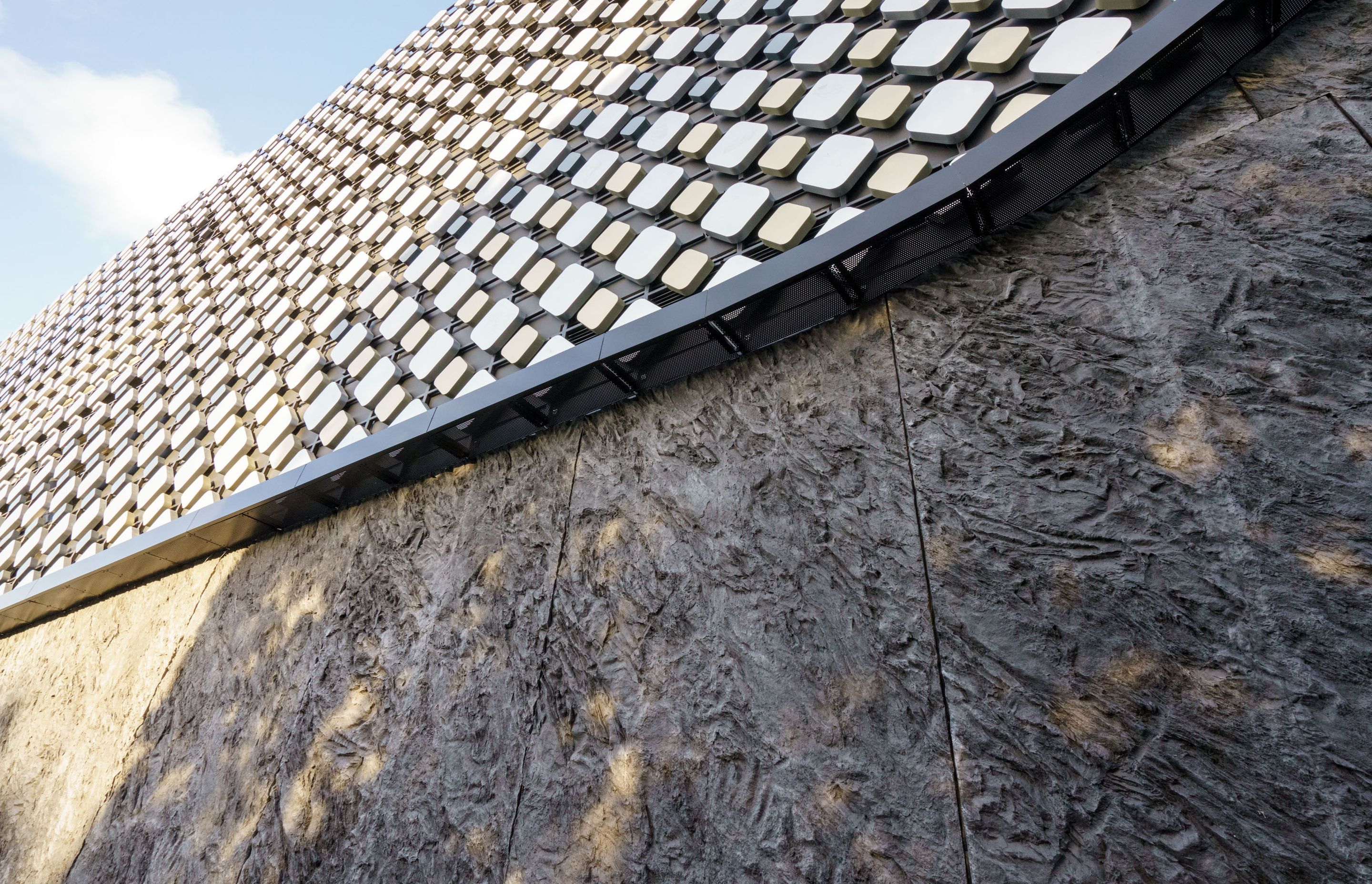 A seven-meter mould with a repeating pattern was created to form the MONARC concrete panels that were tinted with PeterFell SuperBlack to create the desired black granite look.