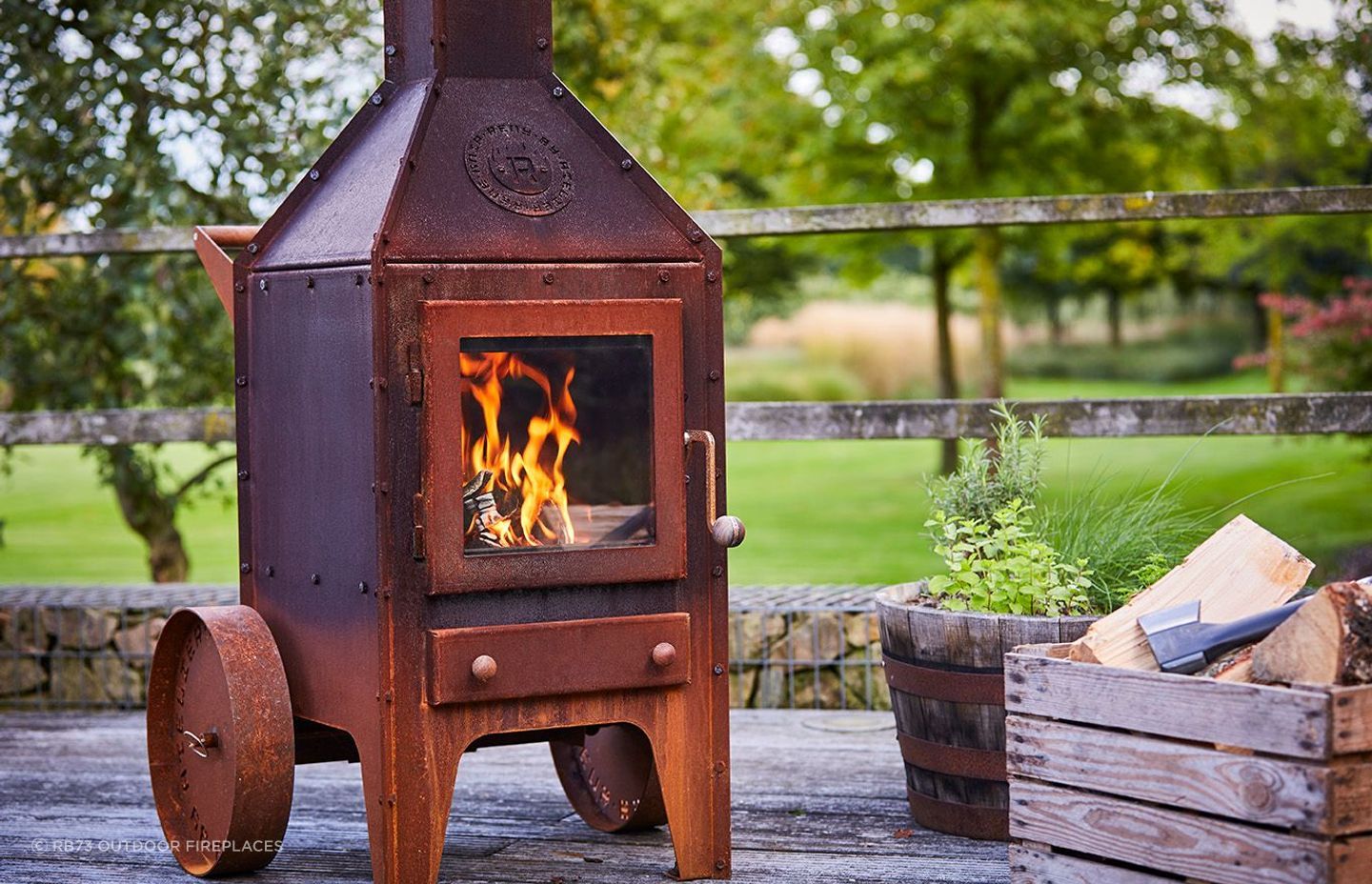 The RB73 Bijuga with wheels By Heat &amp; Grill offers rustic aesthetics and warmth.