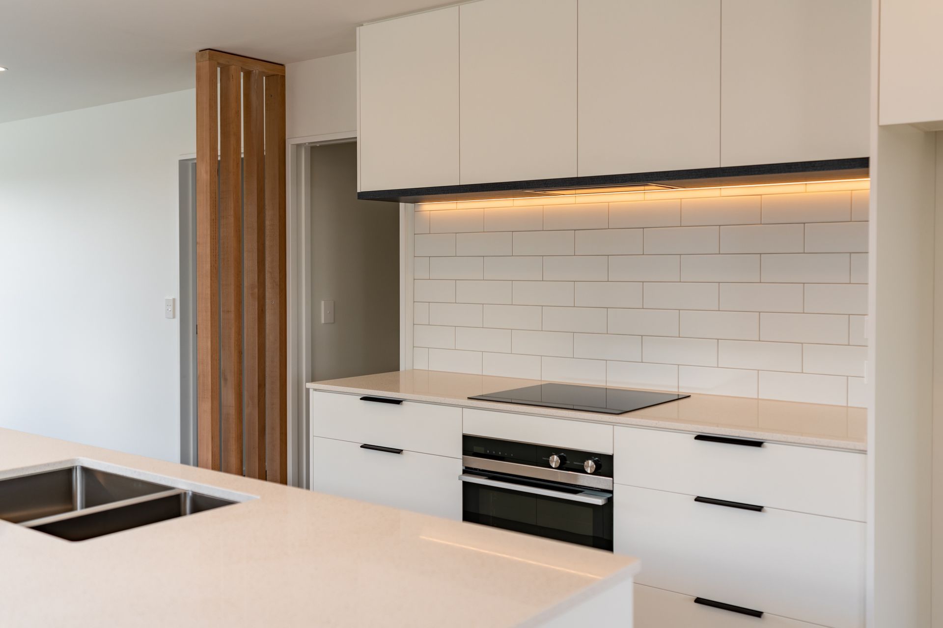 This contemporary kitchen features Fisher & Paykel appliances and a subway tile splashback, designed by Modern Age Kitchens & Joinery.