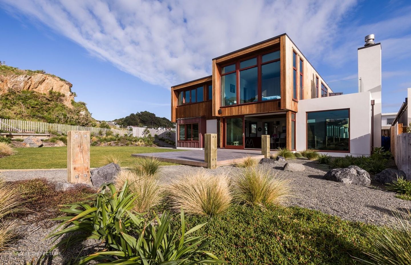 Textural materials complement the rugged landscape of this Seatoun home