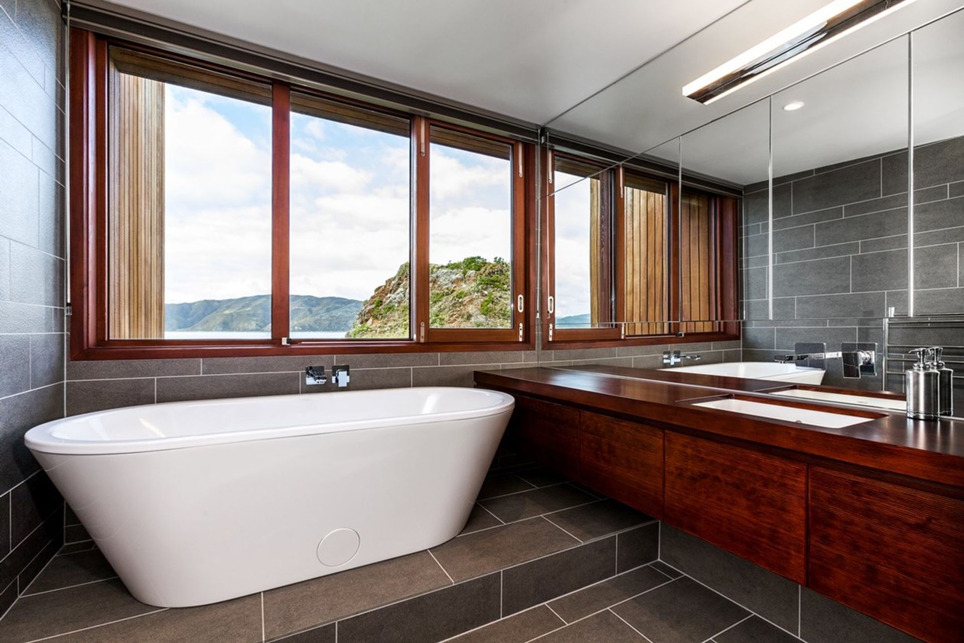 A freestanding bathtub with an exquisite view of natural landscape and surroundings