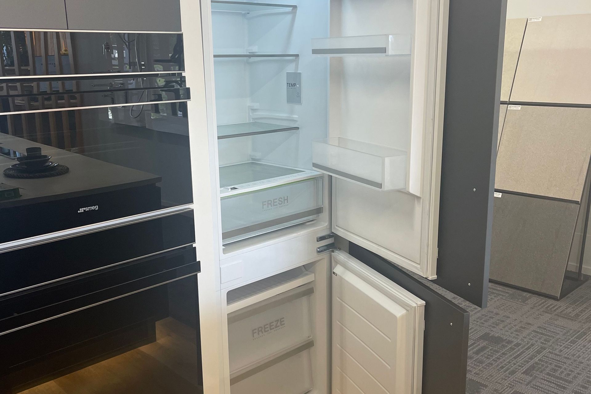 Hidden Fridge and Freezer with cabinet fronts attached to the exterior of the fridge in our Kitchen showroom in Auckland