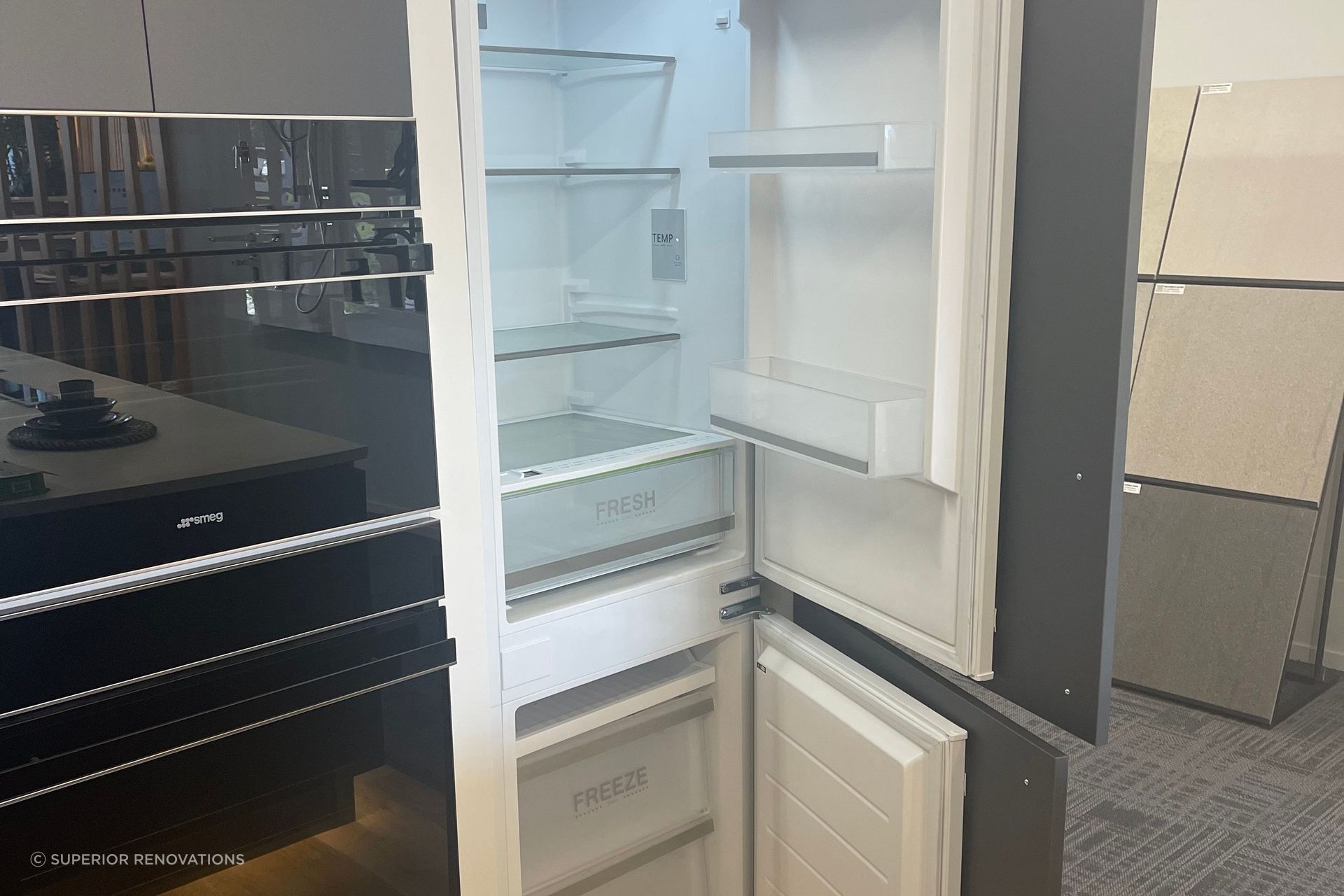 Hidden Fridge and Freezer with cabinet fronts attached to the exterior of the fridge in our Kitchen showroom in Auckland