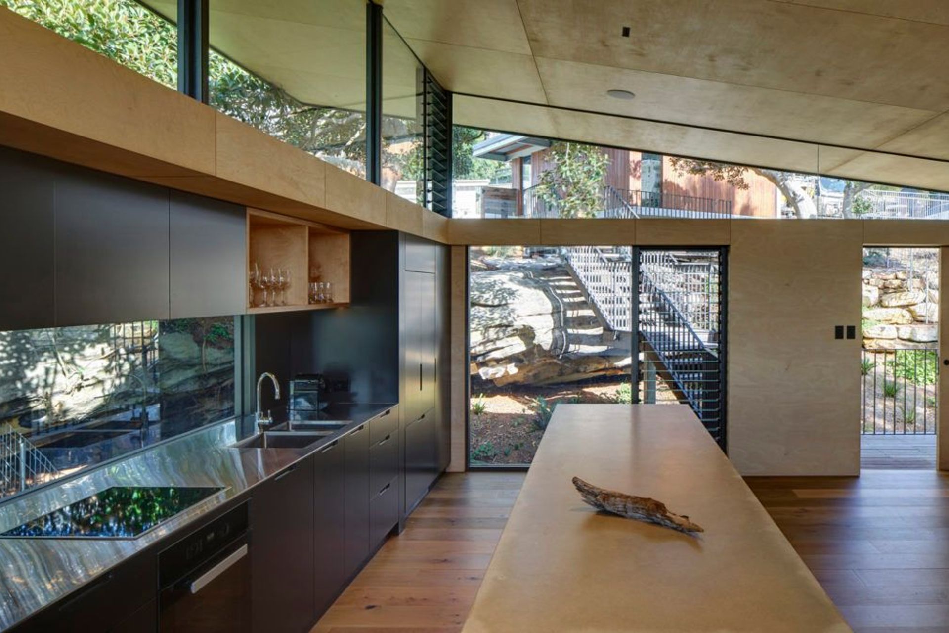 Kitchen opening up to reveal the sandstone rock face