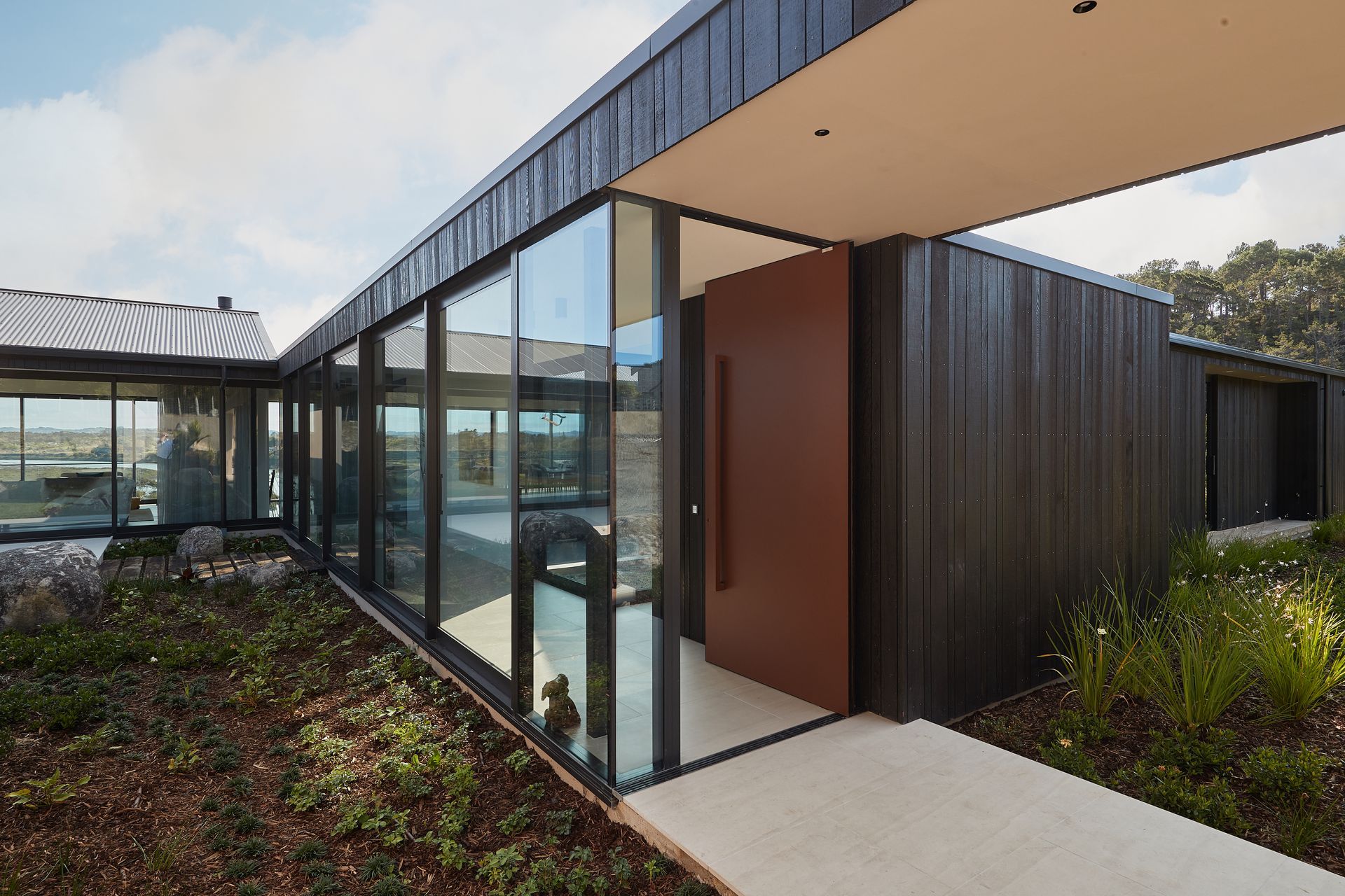This Plasma Entrance Door made from flat sheet aluminium adds a modern, industrial edge to this home
