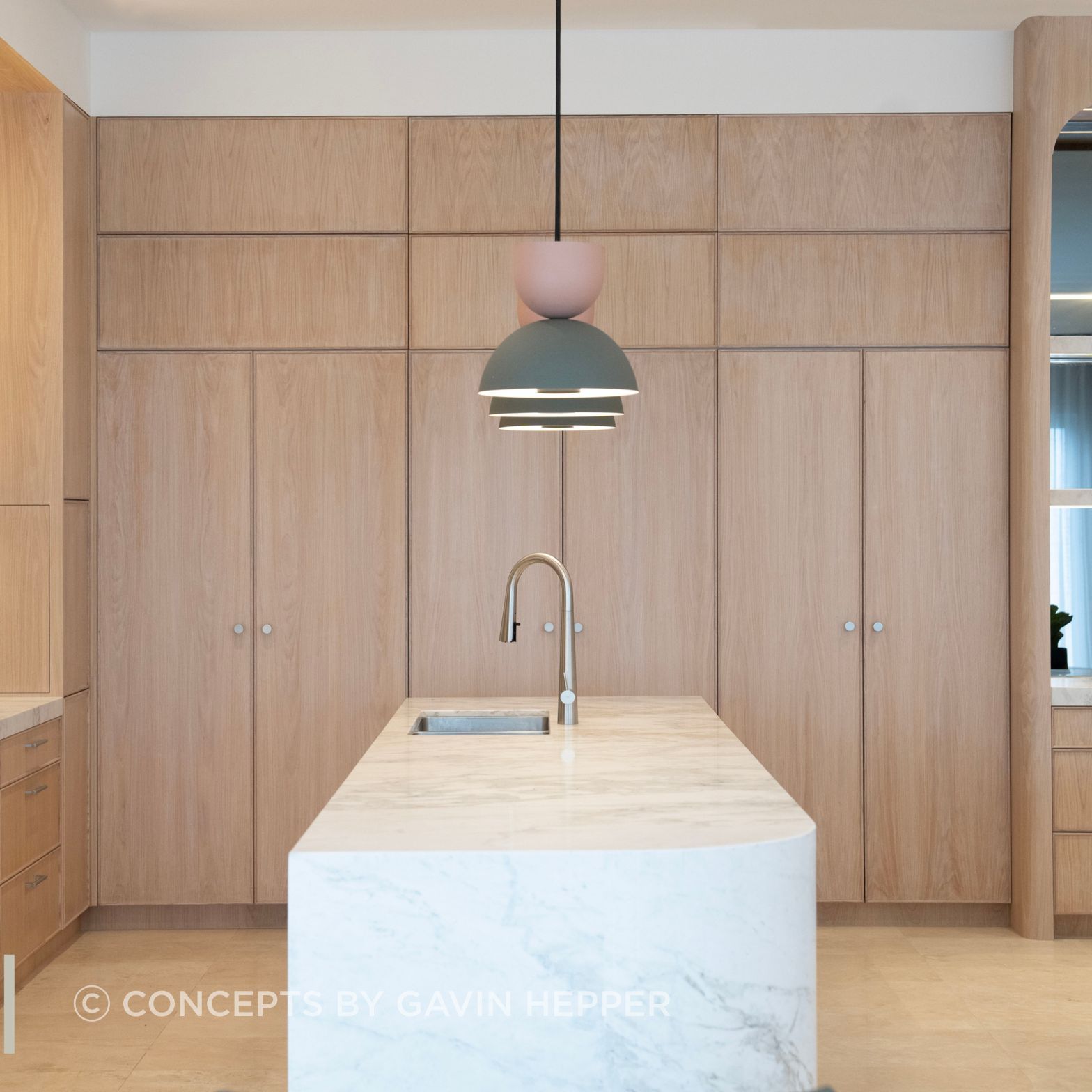 Coastal luxury. Limewash oak cabinetary compliments the beautiful natural stone island.
