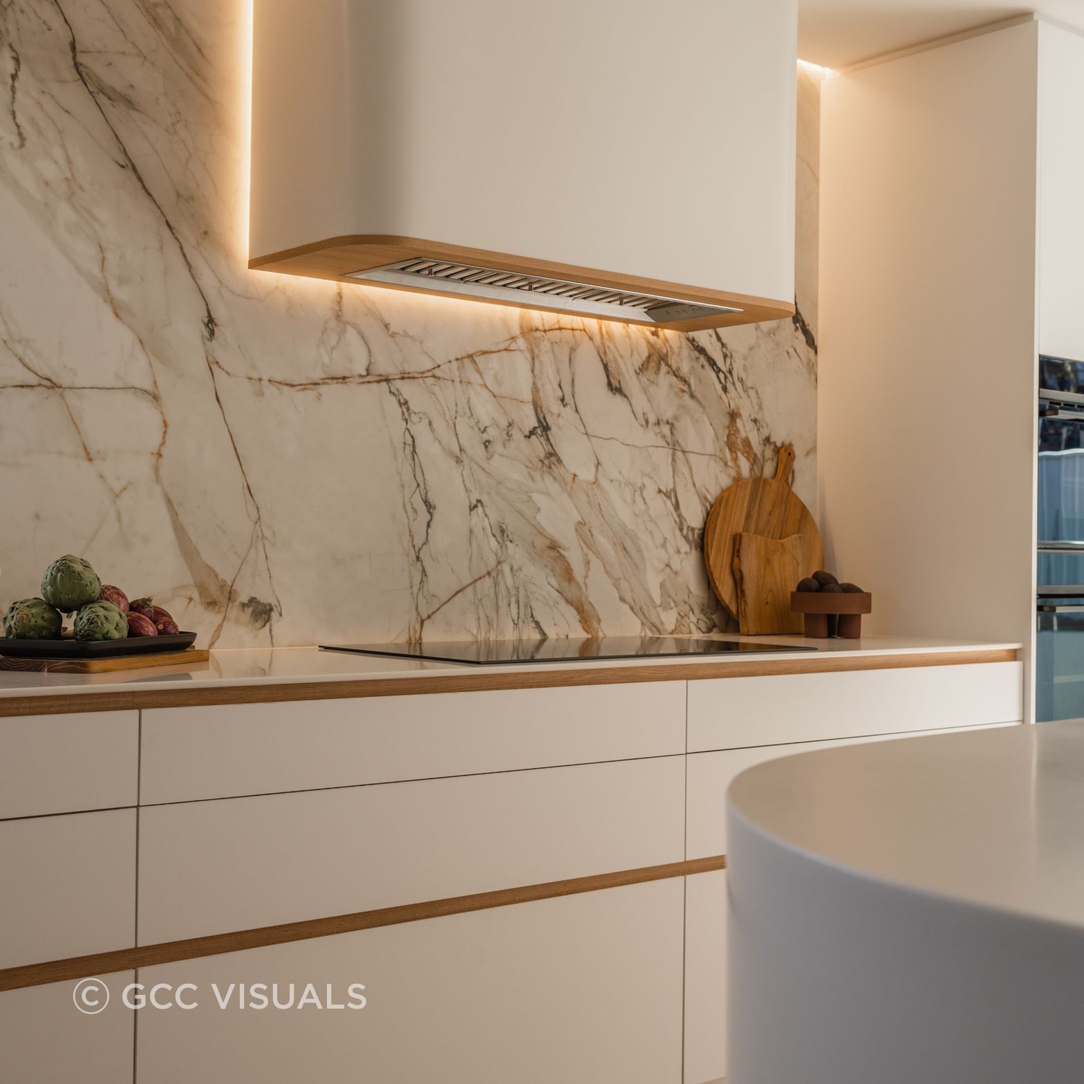 The Avenue. Curved feature rangehood and Neolith Calcatta Luxe splashback are a feature of this coastal kitchen design
