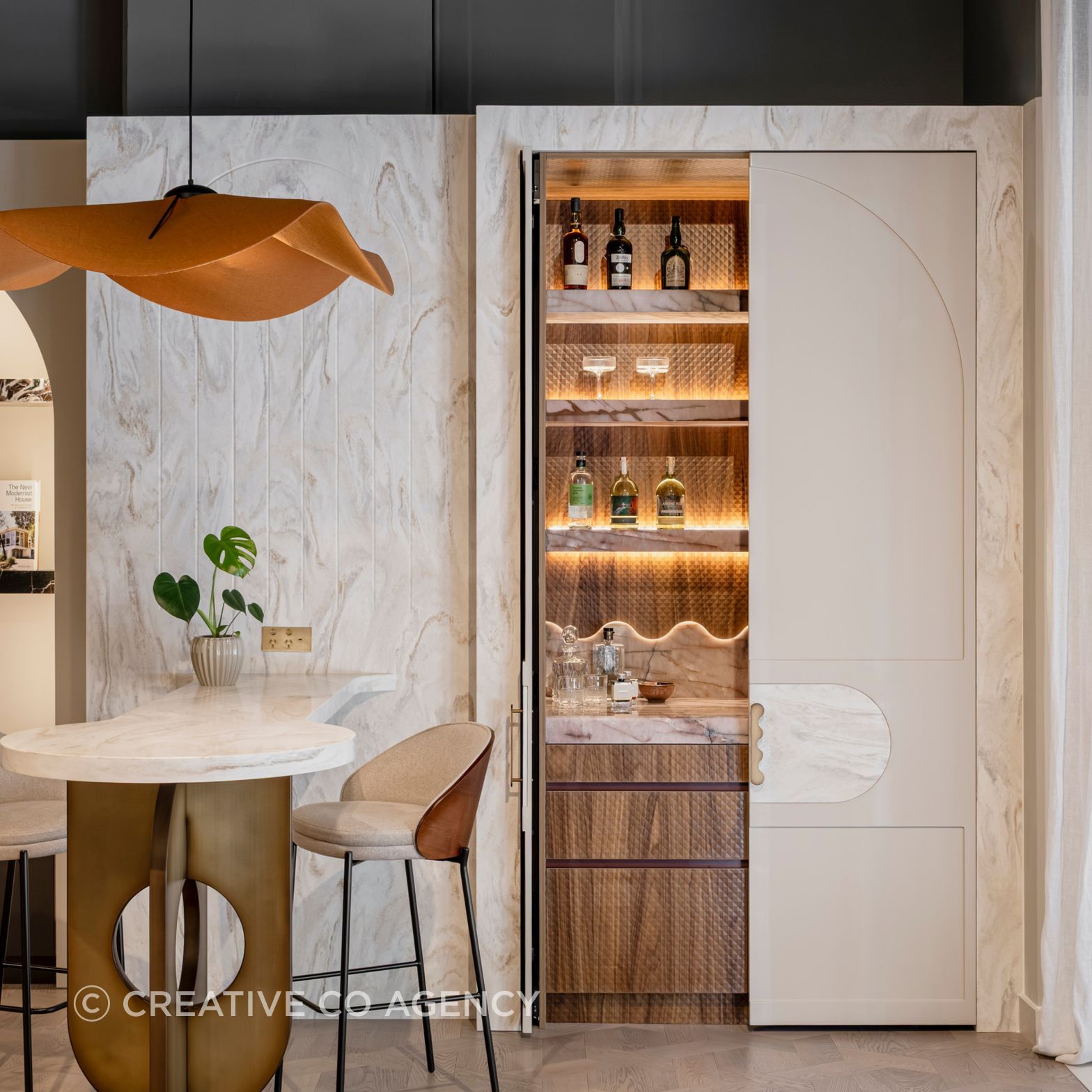 Surprise and Delight. This gorgeous hidden bar features elevated luxe materials, and technical innovation in hardware.