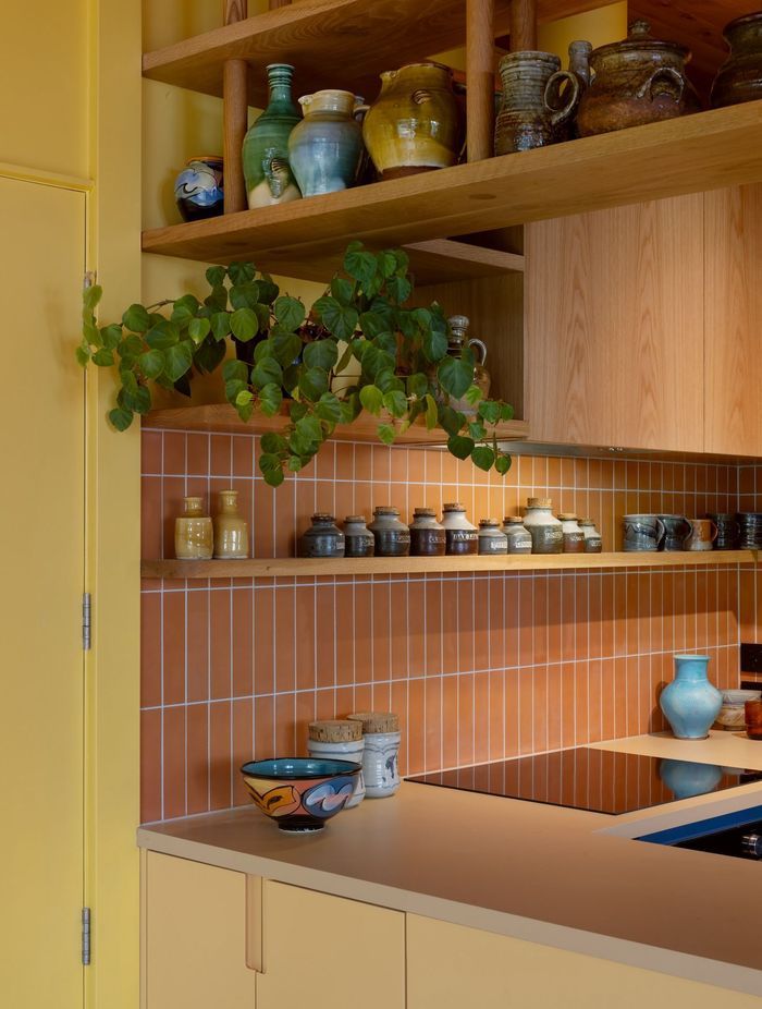Interior Design and Architecture by Chris Corson-Scott and Pac Studio Oak shelving detail and custom cabinetry paired with the artist's collection of handmade kitchen pottery objects and vessels including pieces by Andrew Van Der Putten, Len Castle and Peter Lange