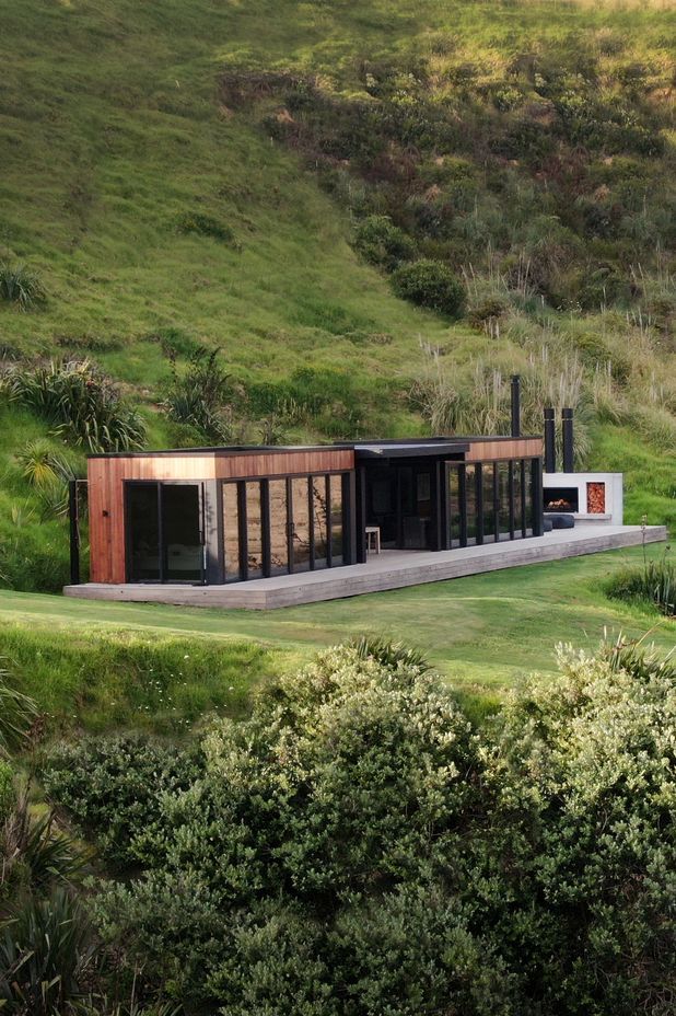 The simple home nestles into the landscape on Bridget's family farm on the Cavalli Coast.