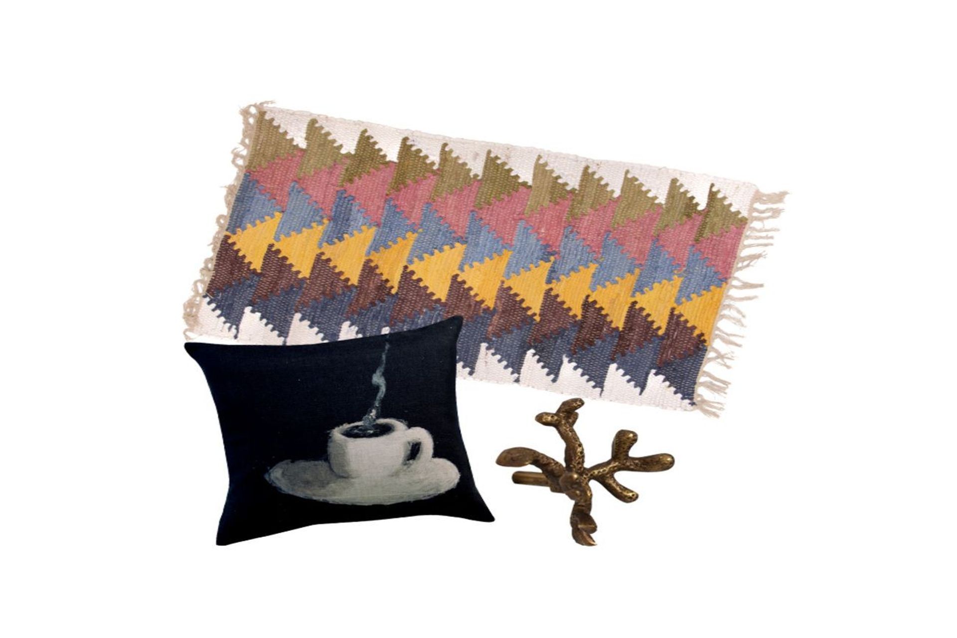 Cotton chindi rug, $59.99, from Trade Aid; Maison Levy Cafe Creme cushion, $259, from Madder &amp; Rouge; Brass drawer knob coral floret, $17.90, from Folklore Store