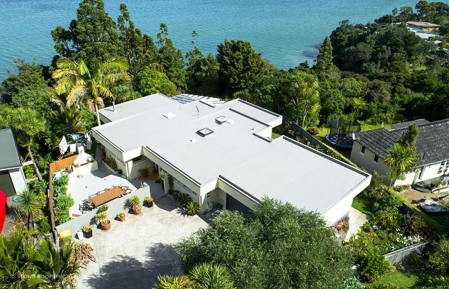 Lighter coloured roofs, such as this one, are termed 'cool roofs' for their ability to help mitigate energy costs and reduce the heat island effect felt in suburbs and cities.