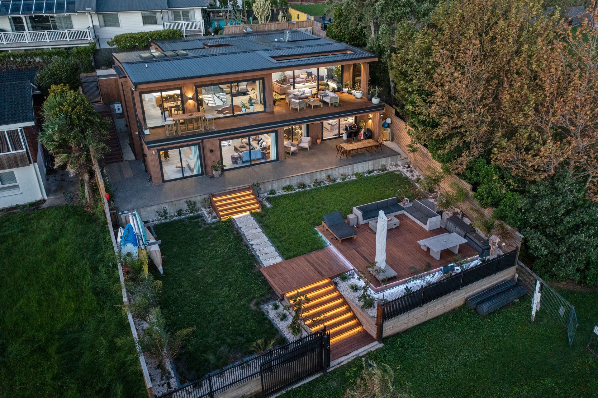 The cedar-clad lakefront property boasts two levels of luxury living space with ample room to entertain guests.