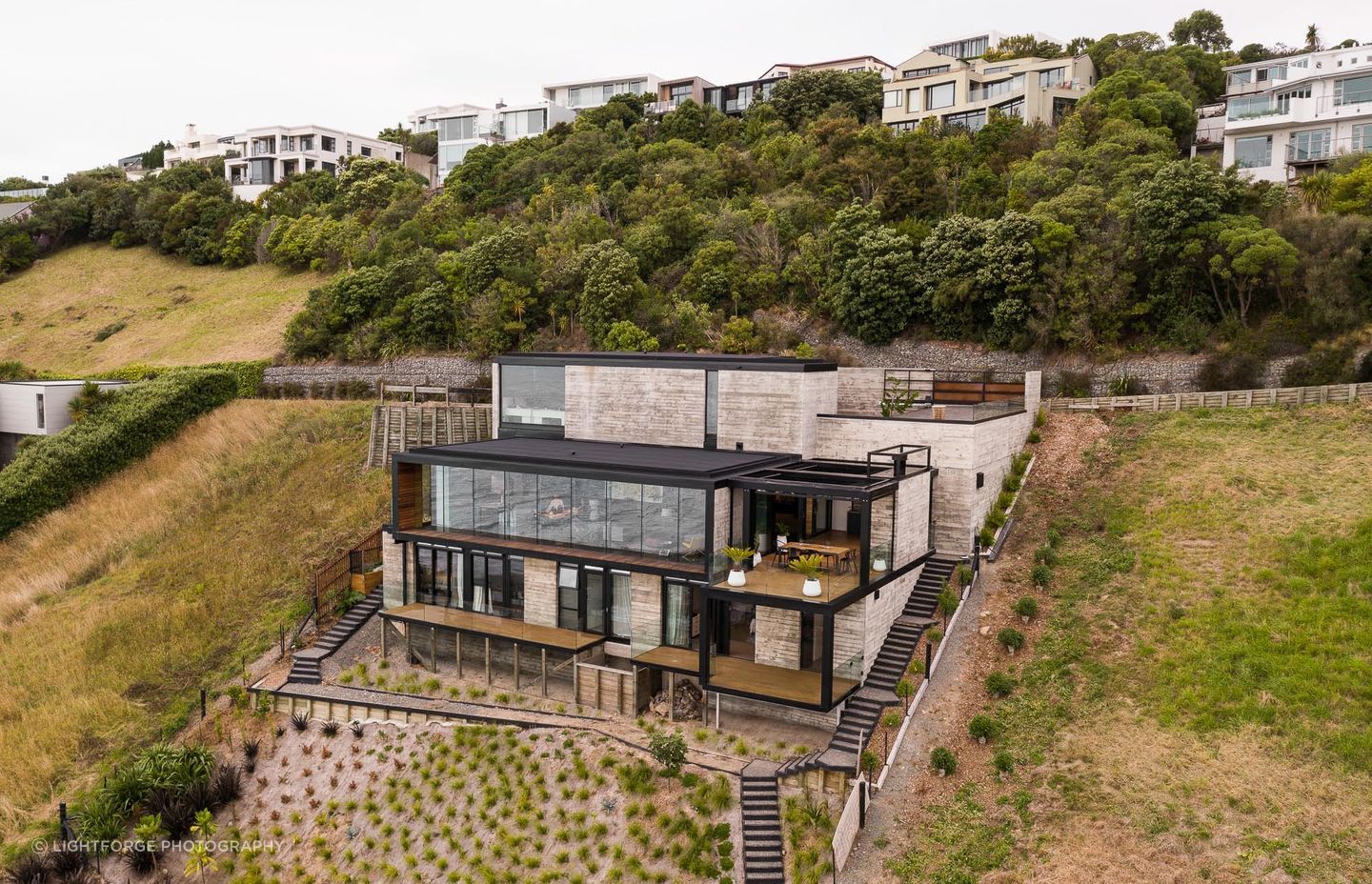 The home's three levels are accessed via a central stair spine and lift.