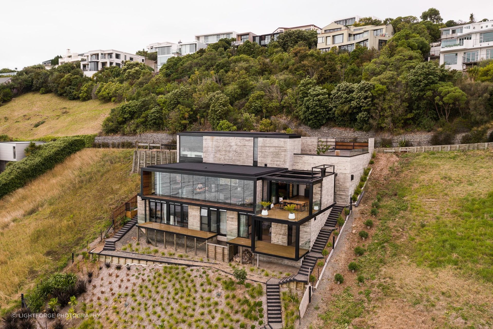 The home's three levels are accessed via a central stair spine and lift.