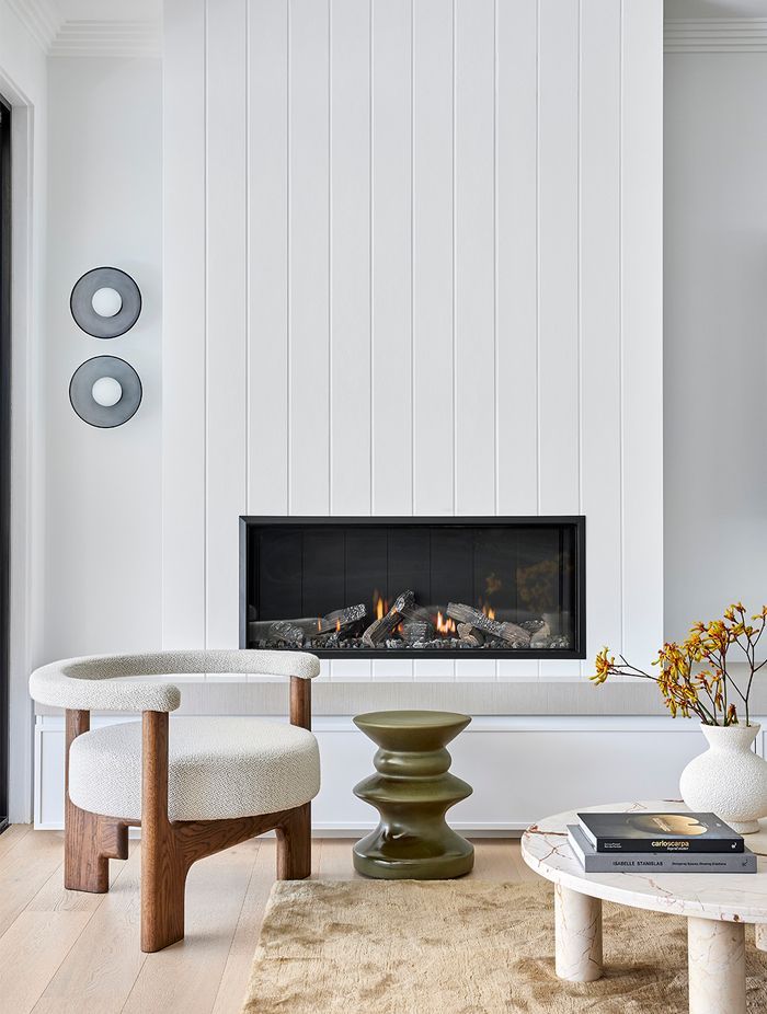 Escea’s Zero Clearance rating allows non-combustible materials to be used around the fire — enabling the fire to be wrapped in panelled white timber, seamlessly blending it into the relaxed textures and coastal tones of the family zone.