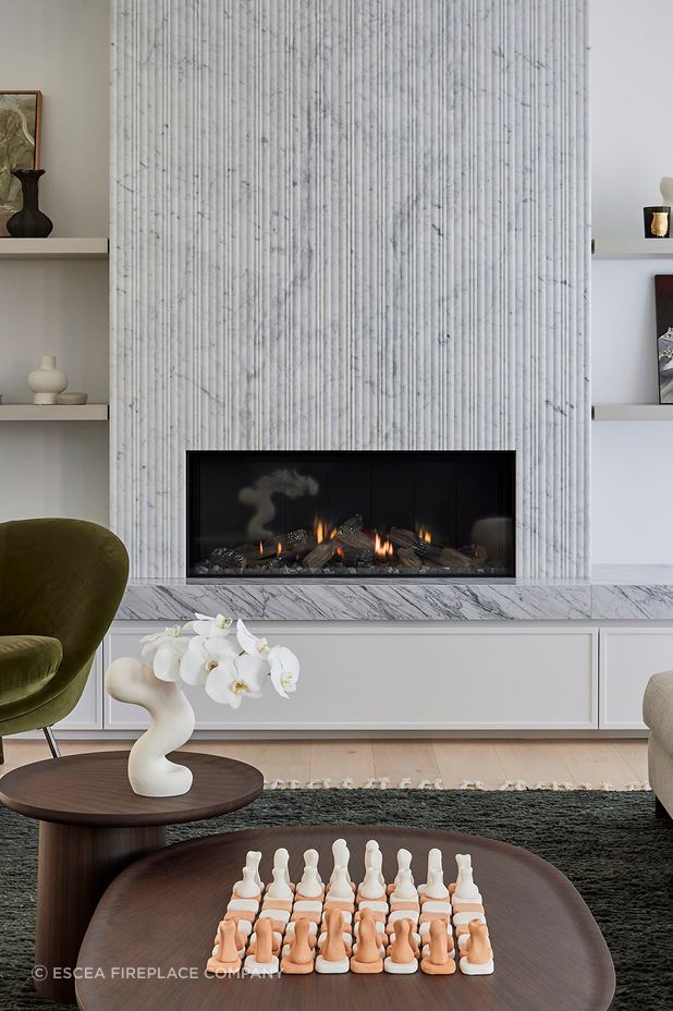 With its sleek, frameless design and advanced Zero Clearance rating, the Escea DS1150 offered complete freedom to execute the vision — seamlessly integrating the fireplace into the stone and marble surround, with custom shaker cabinetry installed directly below.