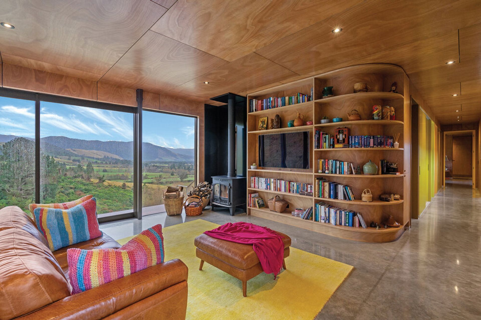 The 10-metre wide windows draw in the winter sun, trapping the warmth in the concrete floor and allowing the owners to walk barefoot in June and July.